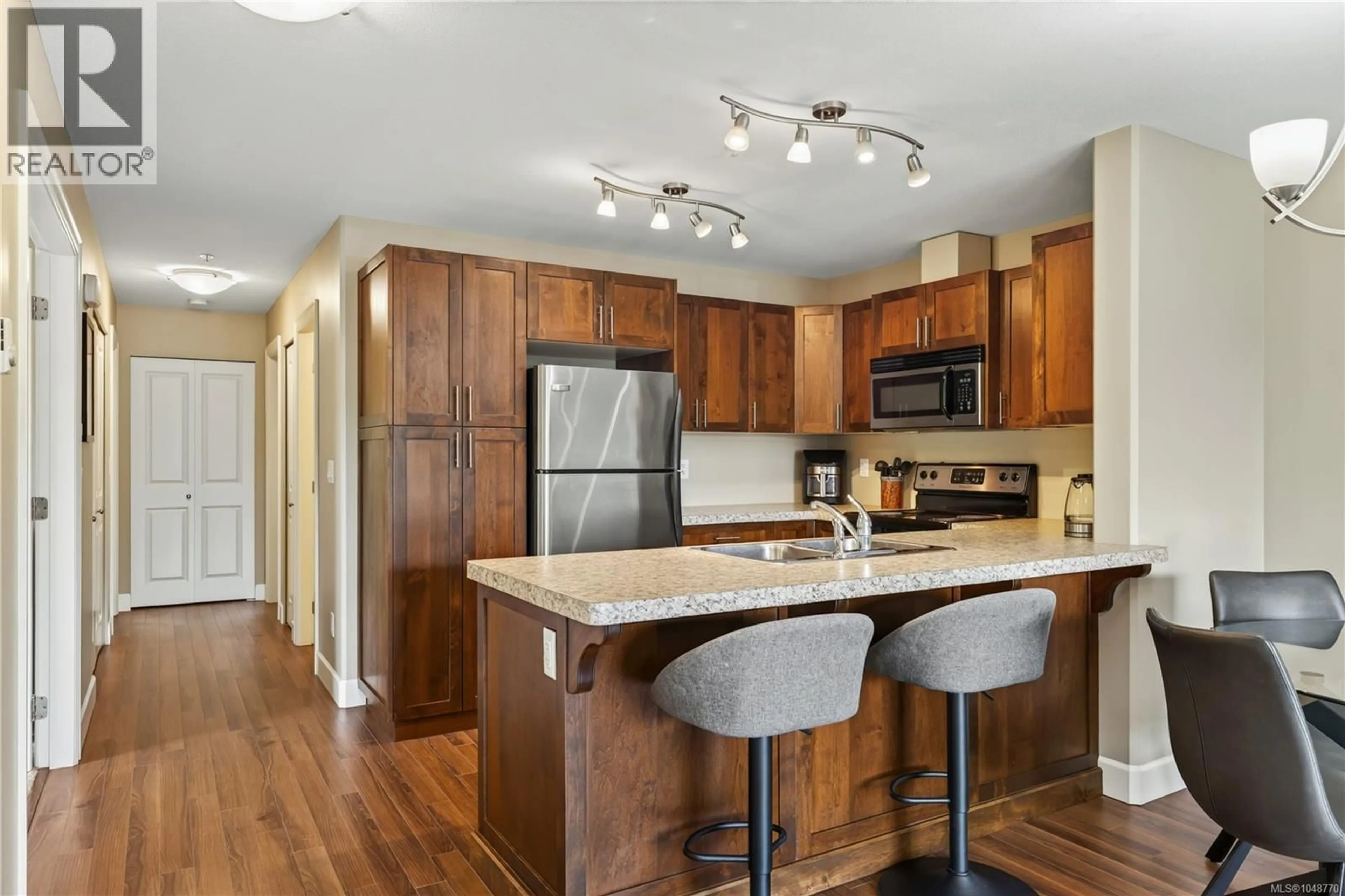 Open concept kitchen, wood/laminate floor for 201 - 5965 KADEN PLACE, Nanaimo British Columbia V9T0B5