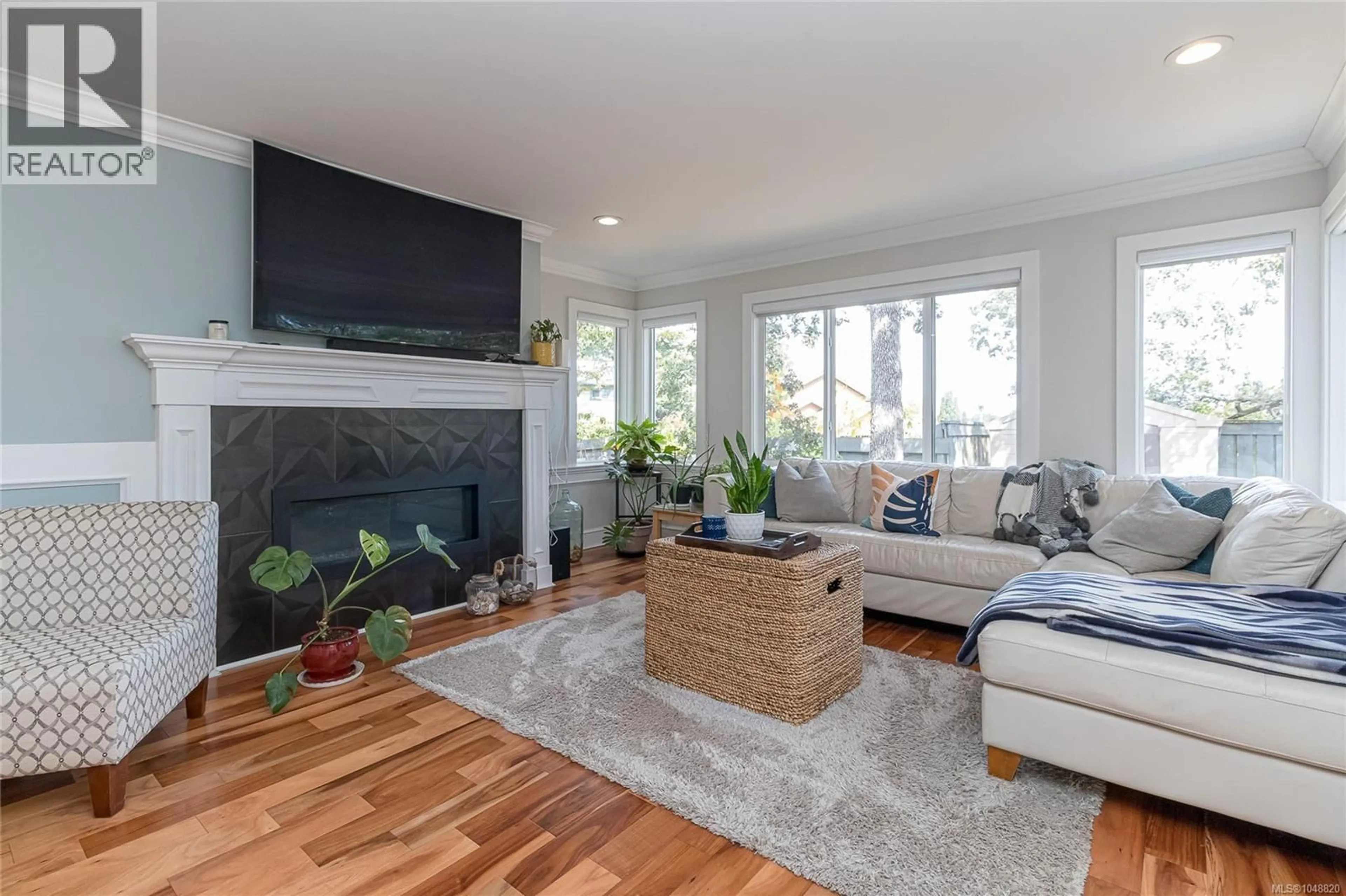 Living room with furniture, wood/laminate floor for 4081 CEDAR HILL ROAD, Saanich British Columbia V8N3C2