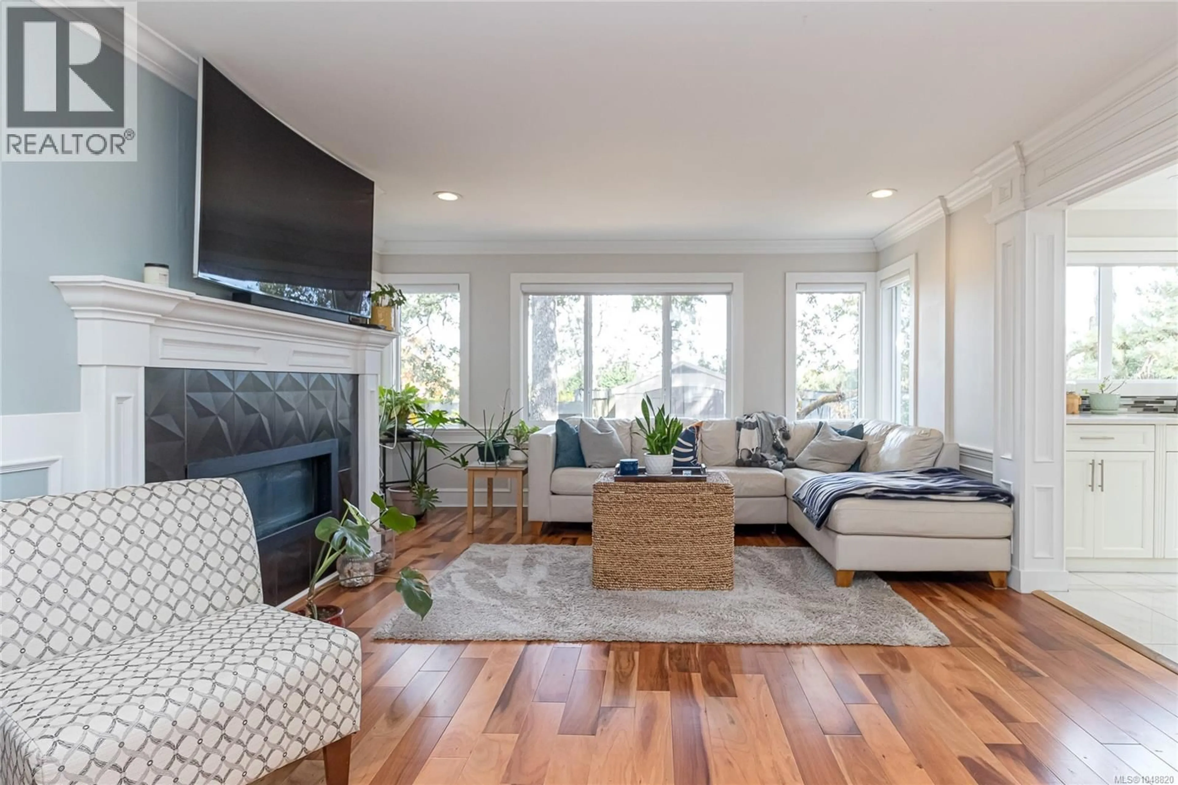 Living room with furniture, wood/laminate floor for 4081 CEDAR HILL ROAD, Saanich British Columbia V8N3C2