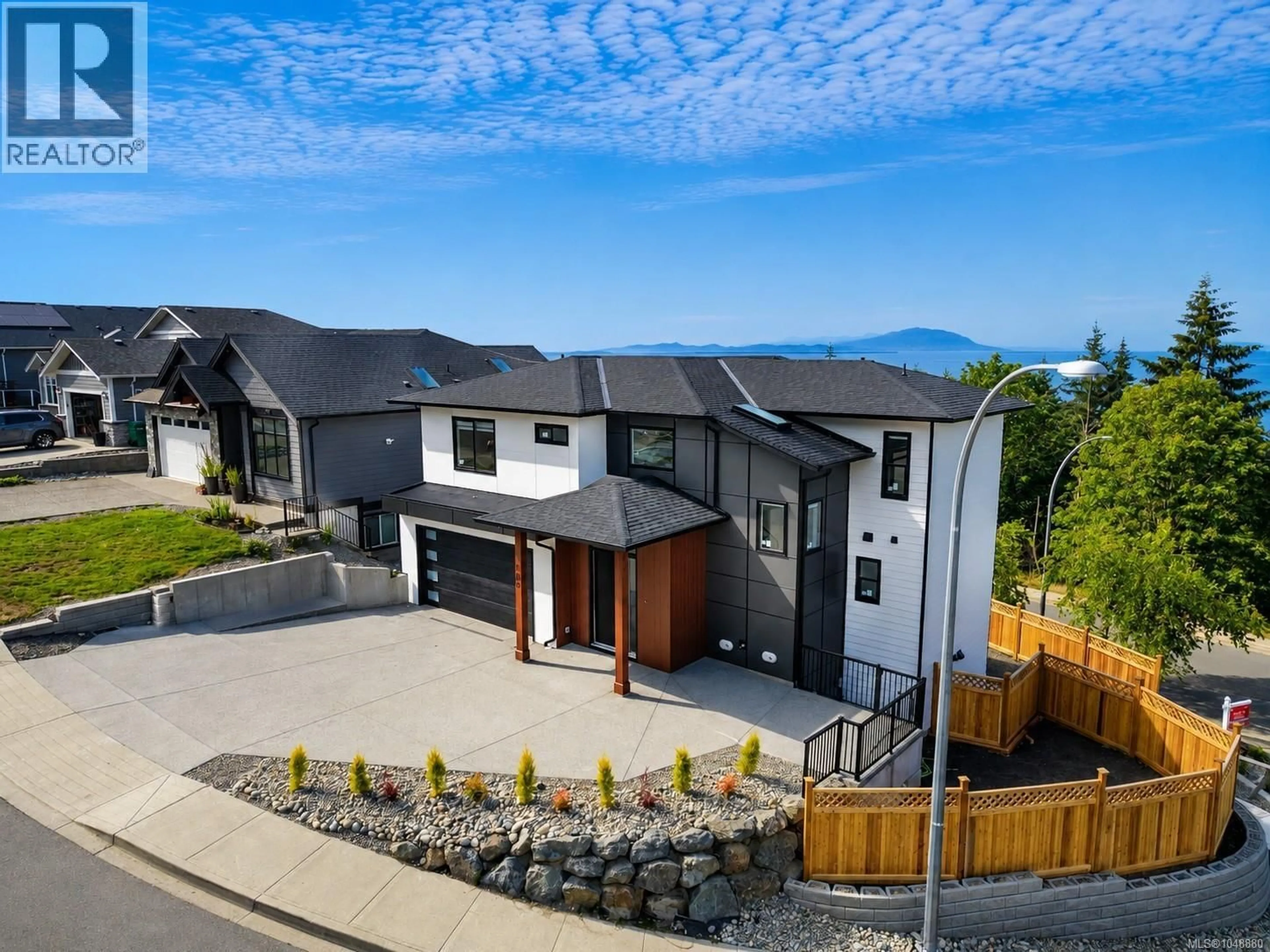 A pic from outside/outdoor area/front of a property/back of a property/a pic from drone, mountain view for 100 ROYAL PACIFIC WAY, Nanaimo British Columbia V9T5L7
