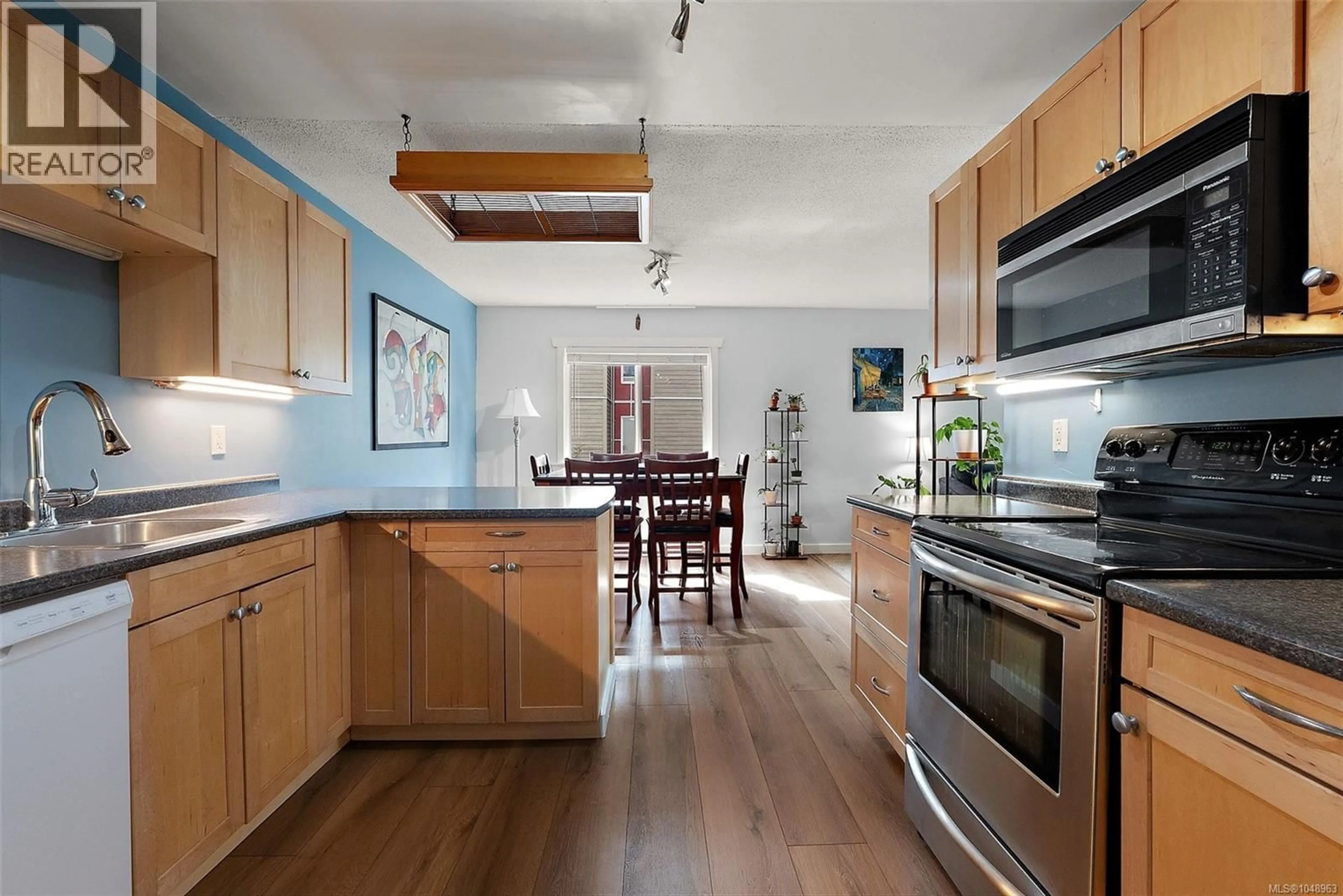 Open concept kitchen, wood/laminate floor for 216 - 3235 QUADRA STREET, Saanich British Columbia V8X1G4