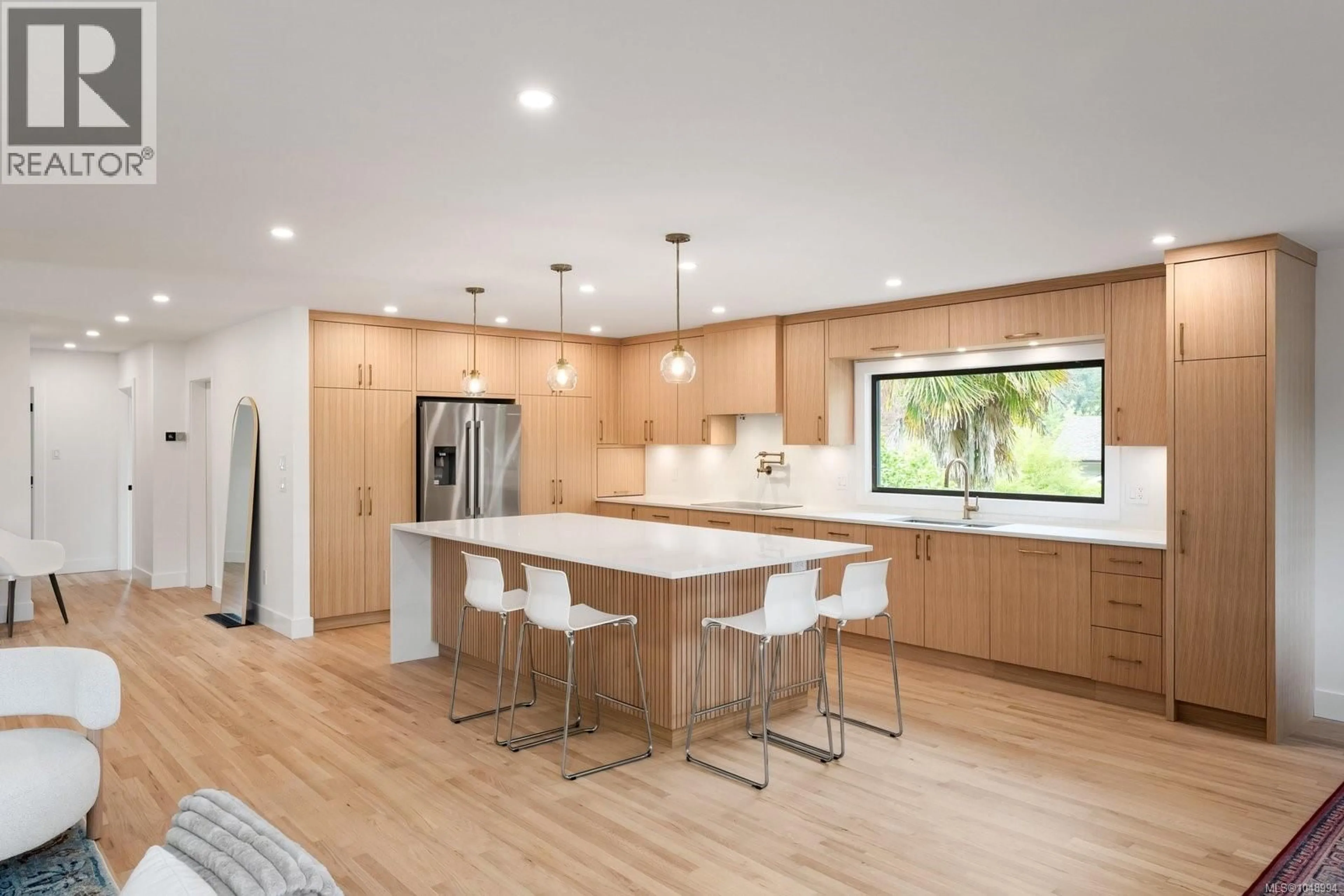 Open concept kitchen, wood/laminate floor for 1601 MILEVA LANE, Saanich British Columbia V8N2V6