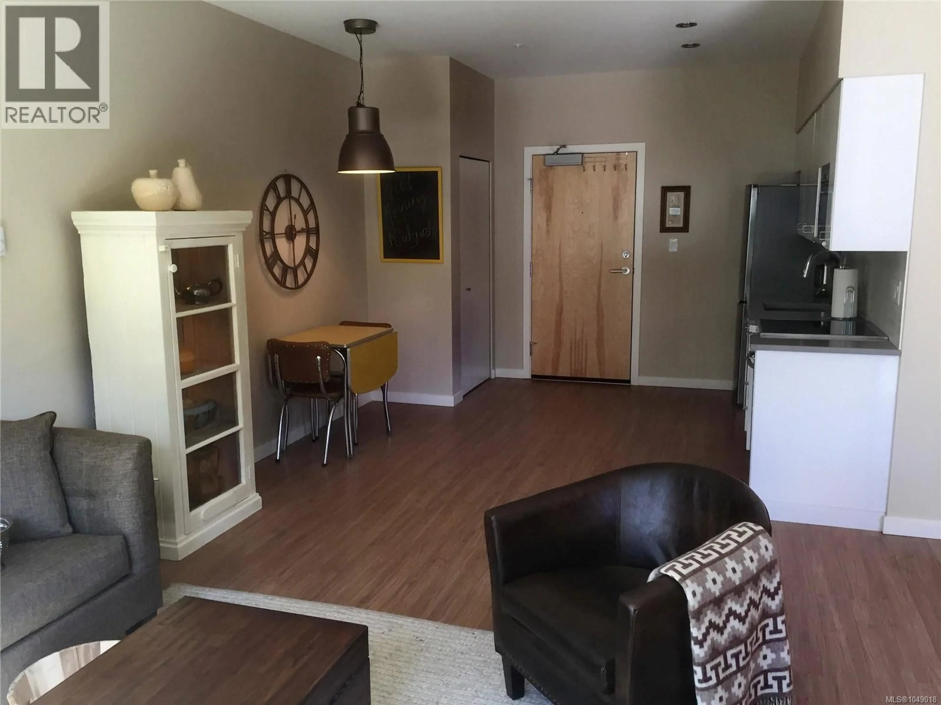 Living room with furniture, wood/laminate floor for 103 - 785 TYEE ROAD, Victoria British Columbia V9A7R5