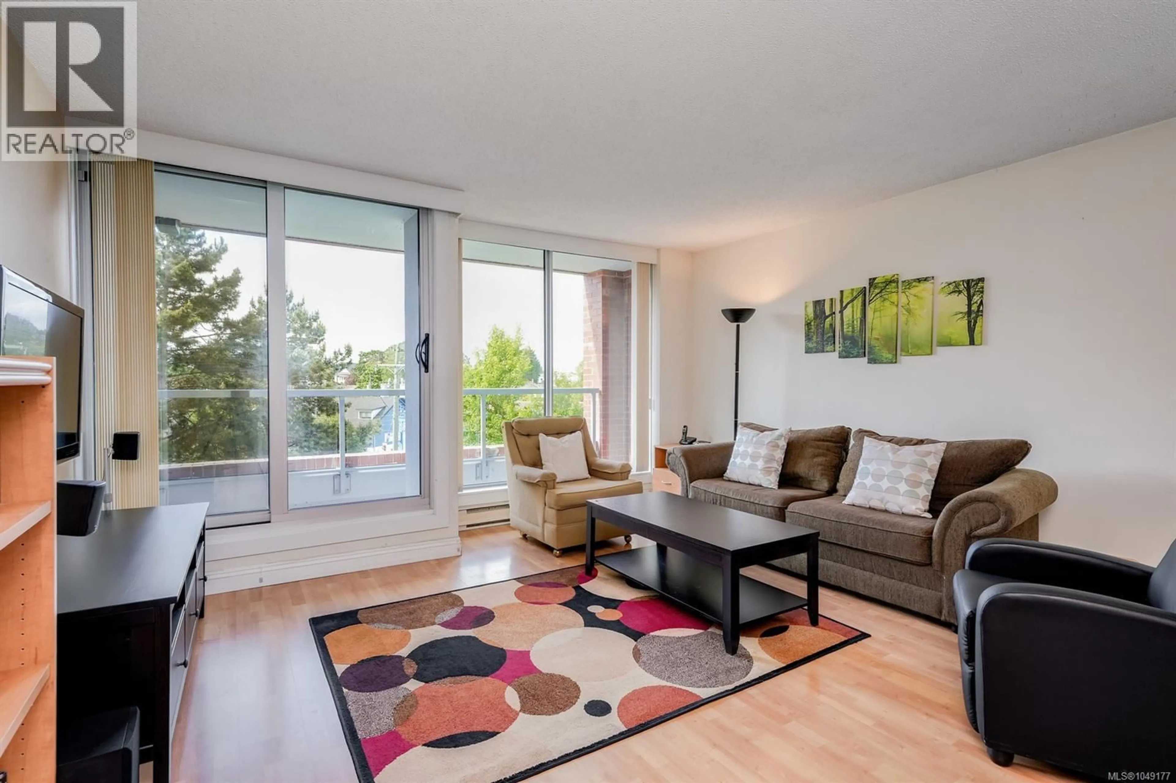 Living room with furniture, wood/laminate floor for 501 - 327 MAITLAND STREET, Victoria British Columbia V9A7G7