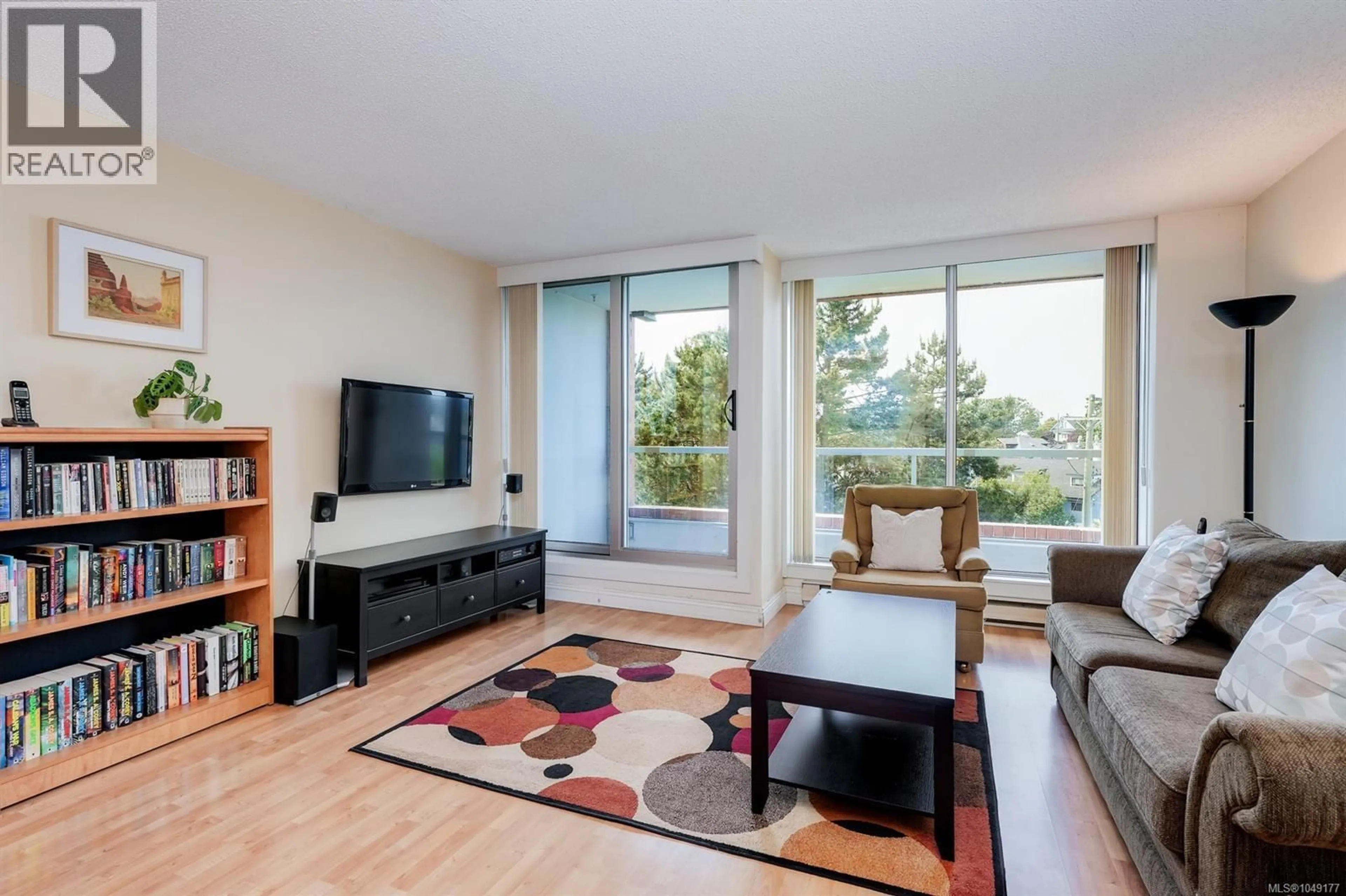 Living room with furniture, wood/laminate floor for 501 - 327 MAITLAND STREET, Victoria British Columbia V9A7G7