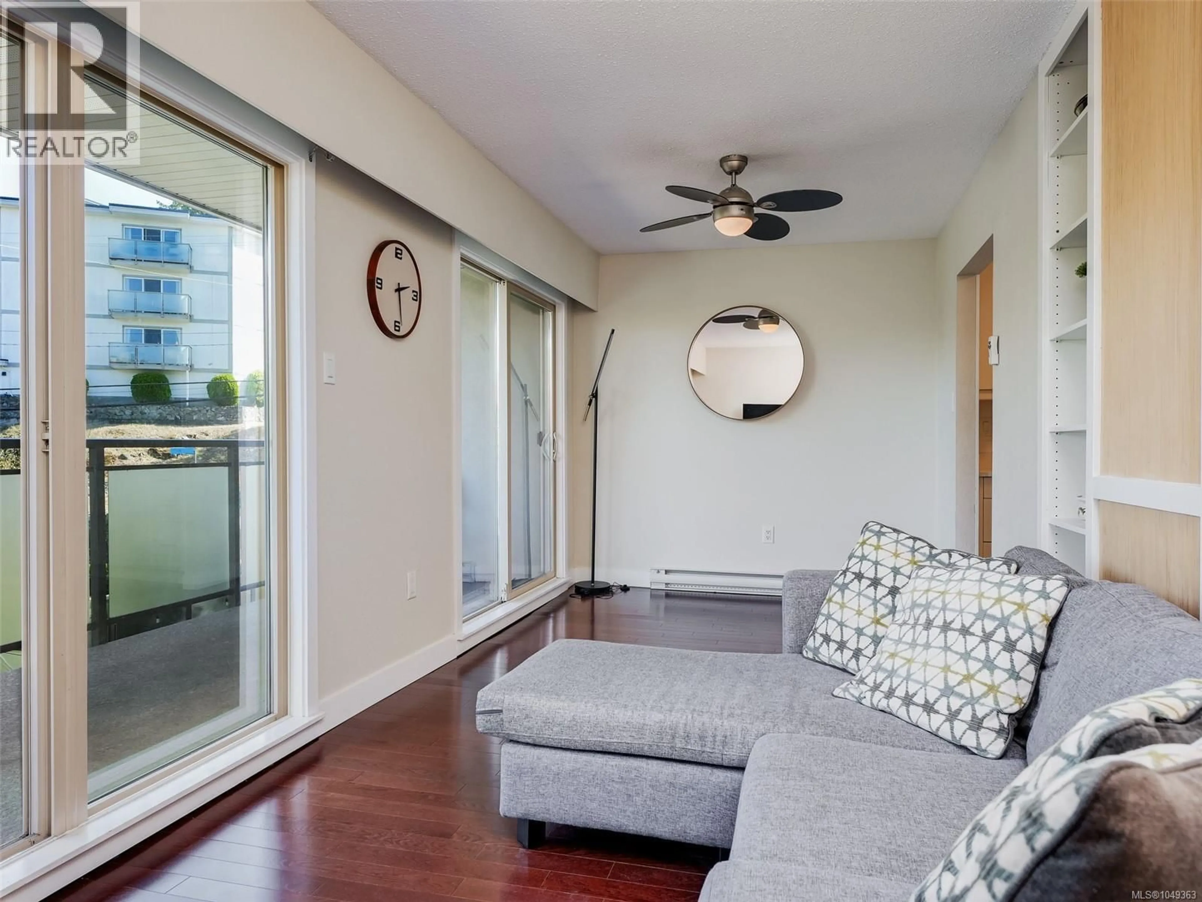 Living room with furniture, wood/laminate floor for 206 - 1545 PANDORA AVENUE, Victoria British Columbia V8R6R1