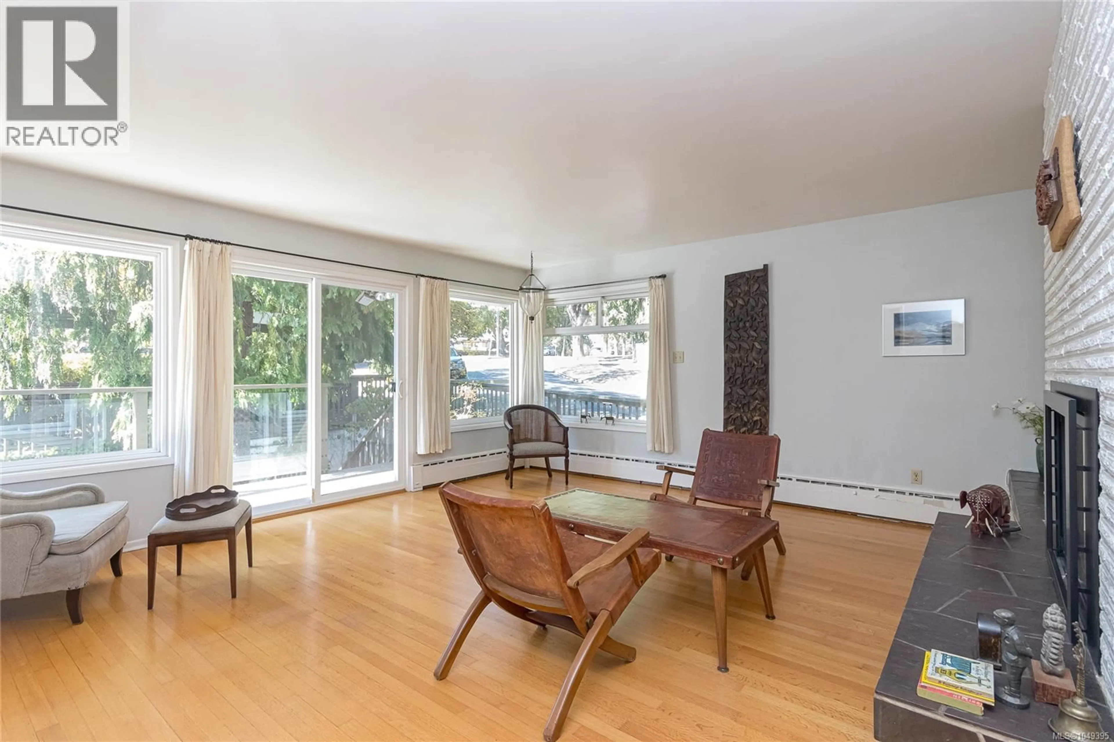 Living room with furniture, wood/laminate floor for 1030 JOAN CRESCENT, Victoria British Columbia V8S3L5