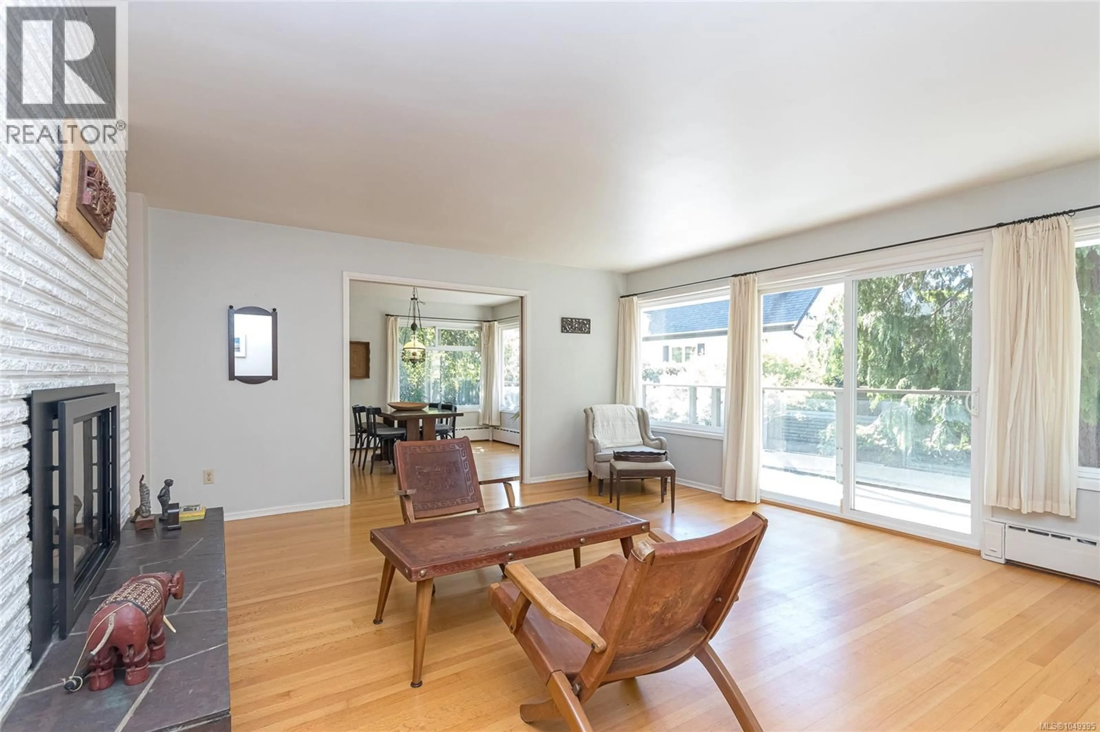 Living room with furniture, wood/laminate floor for 1030 JOAN CRESCENT, Victoria British Columbia V8S3L5