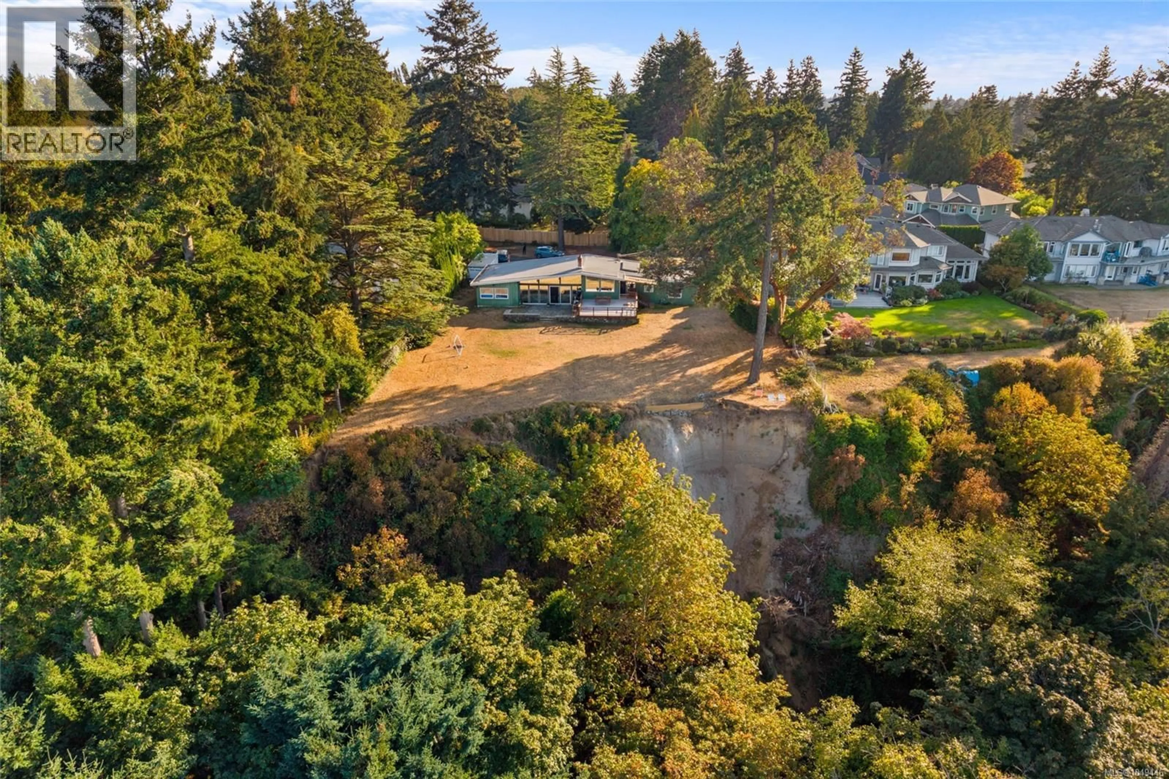 A pic from outside/outdoor area/front of a property/back of a property/a pic from drone, forest/trees view for 4598 TORQUAY DRIVE, Saanich British Columbia V8N3L7
