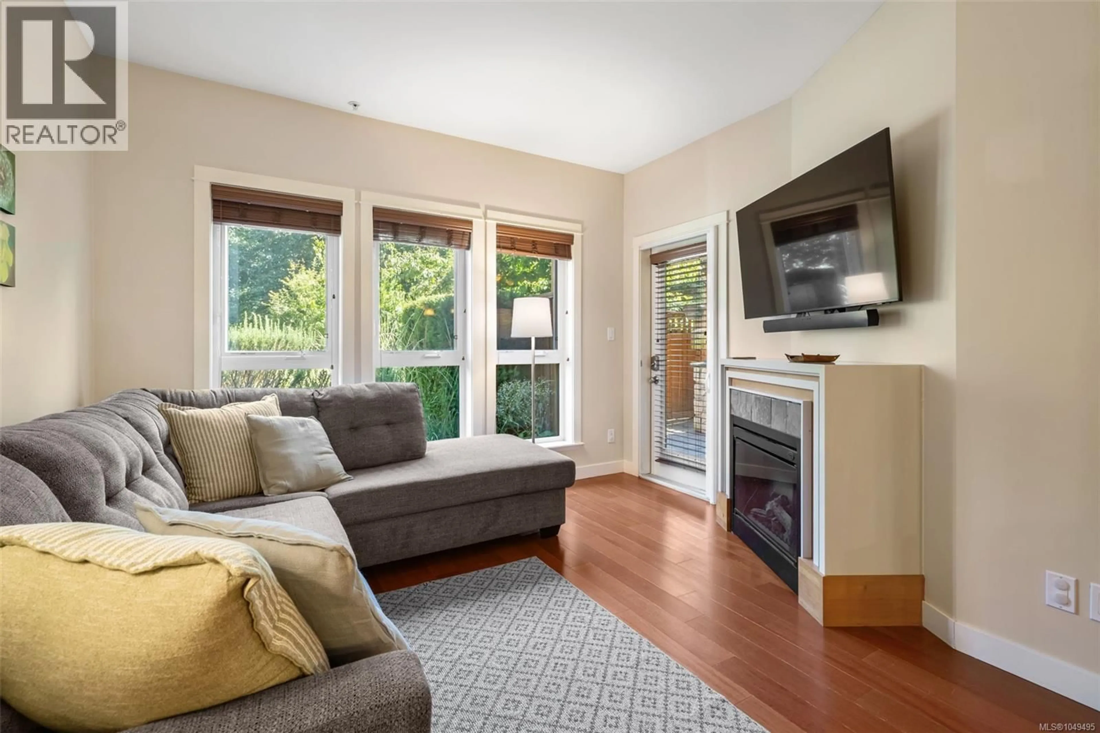 Living room with furniture, wood/laminate floor for 105 - 101 NURSERY HILL DRIVE, View Royal British Columbia V9B0H5