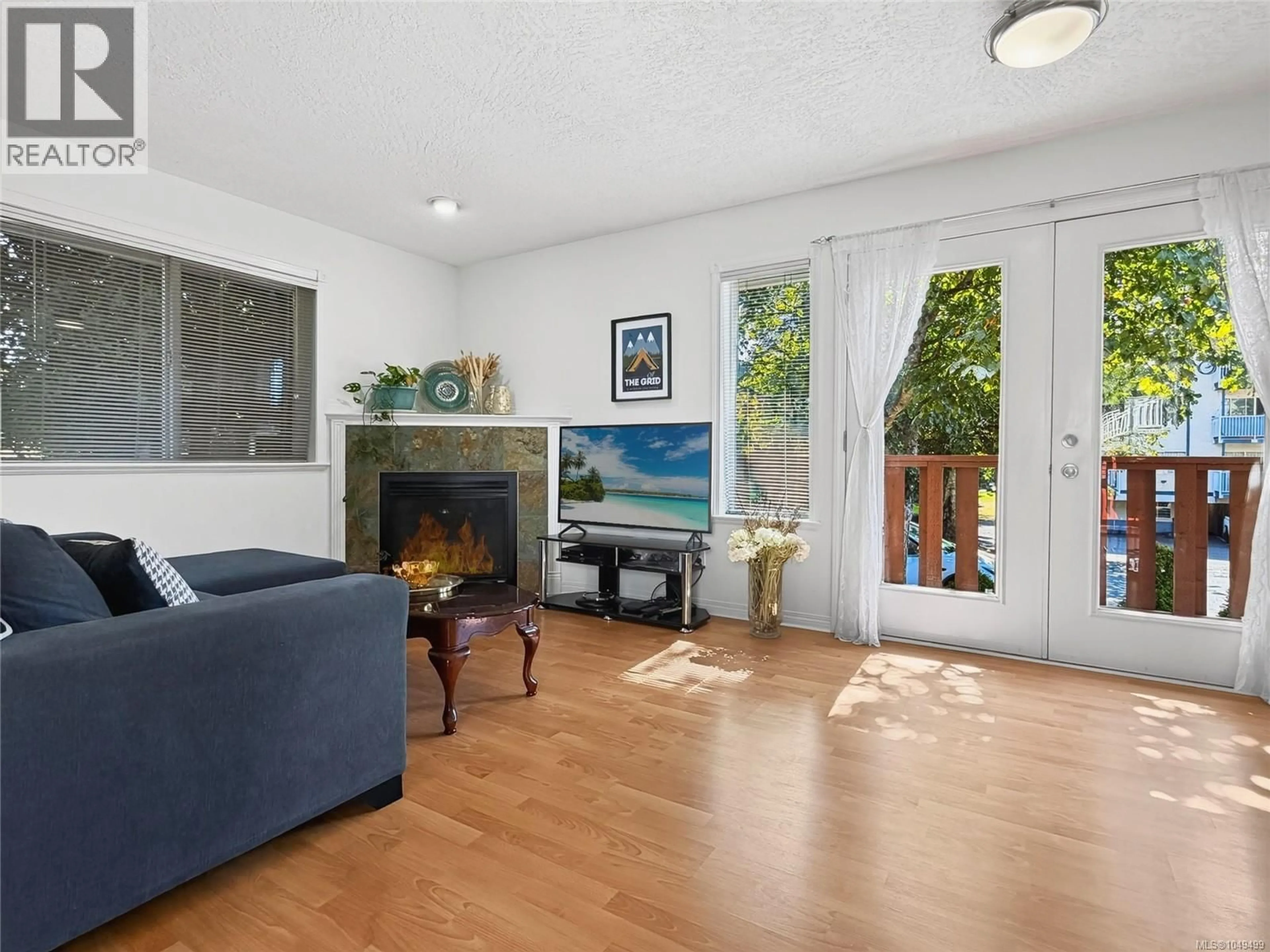Living room with furniture, wood/laminate floor for 1310 BASIL AVENUE, Victoria British Columbia V8T3N2
