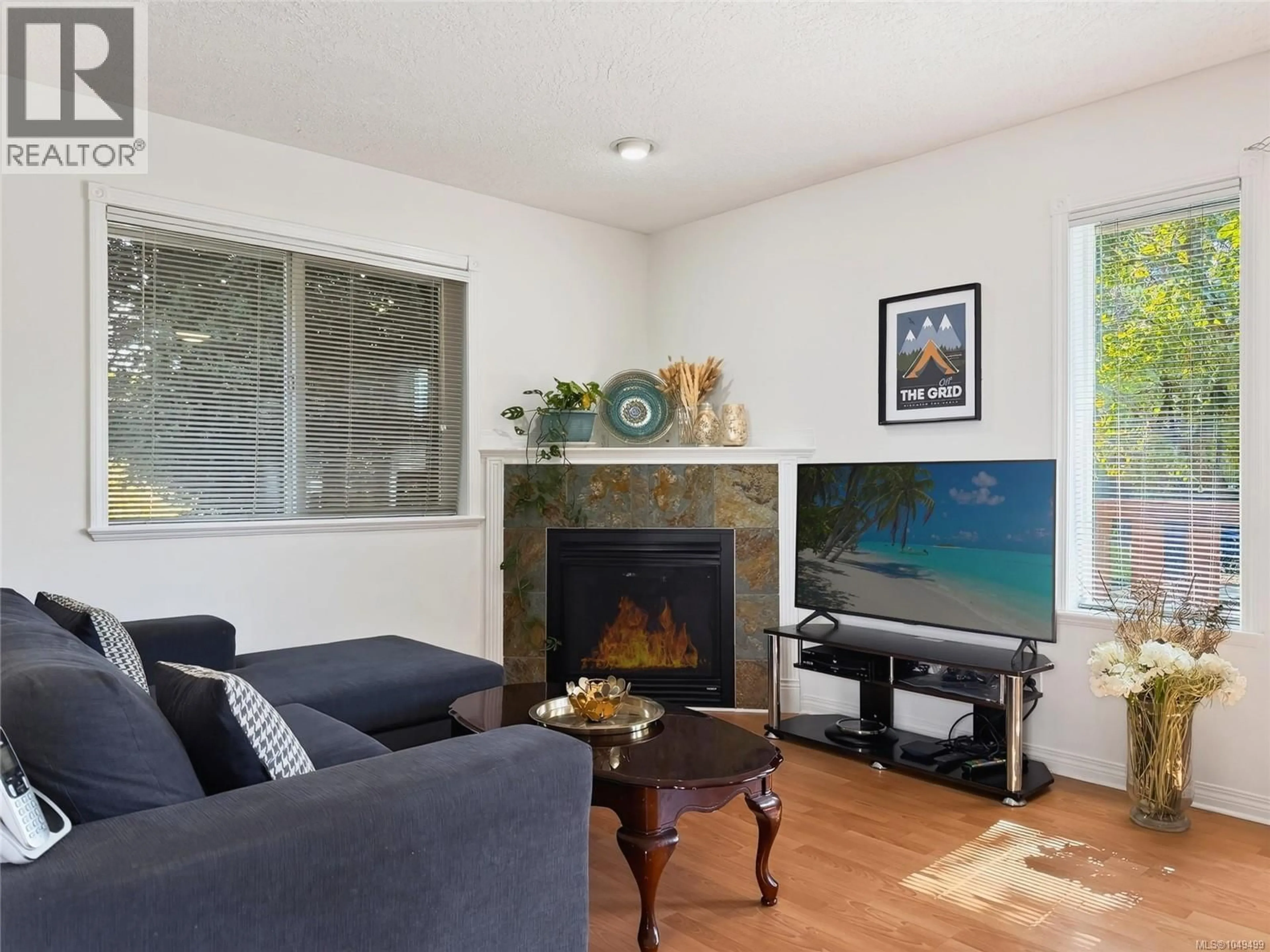 Living room with furniture, wood/laminate floor for 1310 BASIL AVENUE, Victoria British Columbia V8T3N2