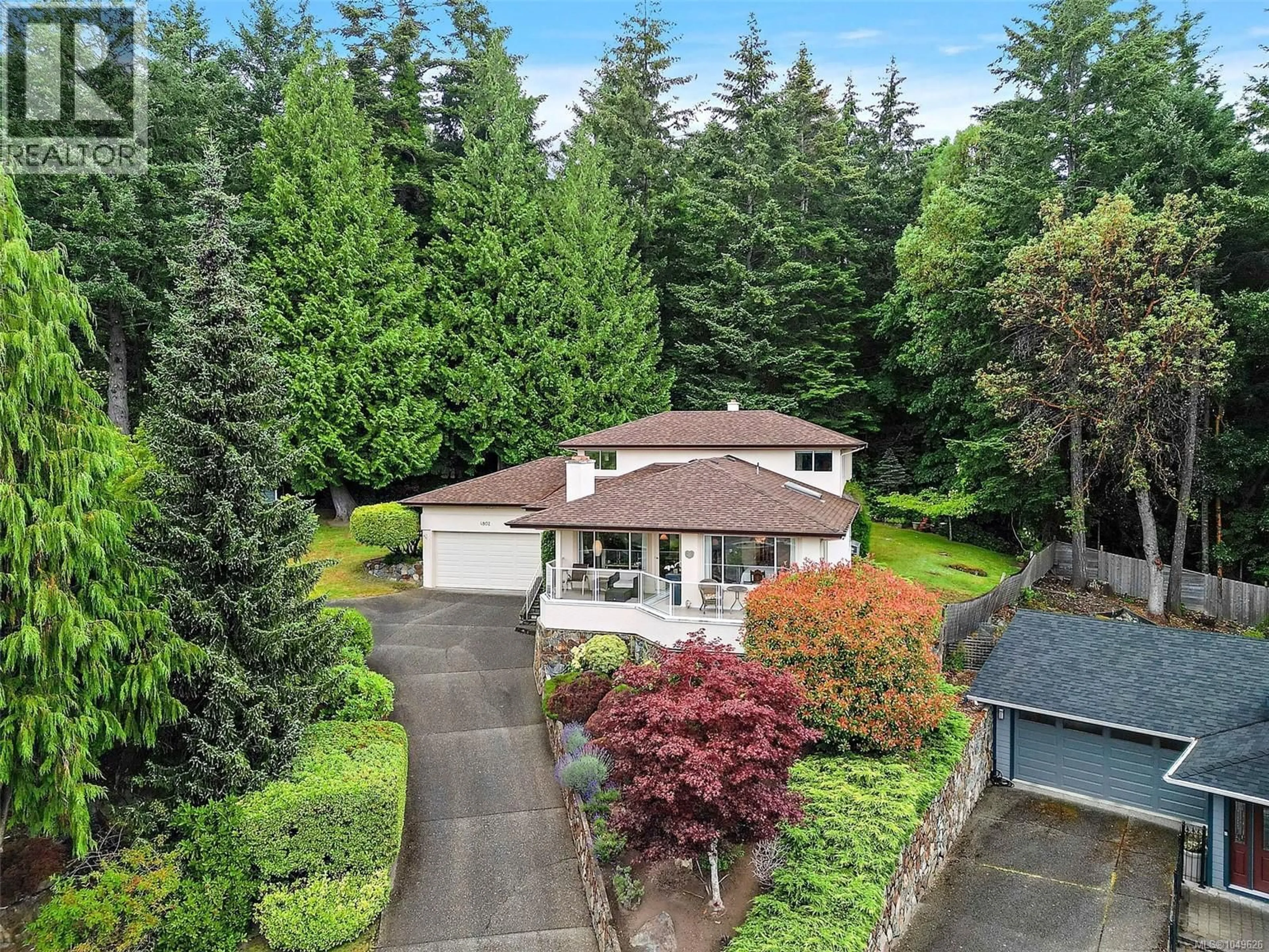A pic from outside/outdoor area/front of a property/back of a property/a pic from drone, street for 4802 AMBLEWOOD DRIVE, Saanich British Columbia V8Y2S3