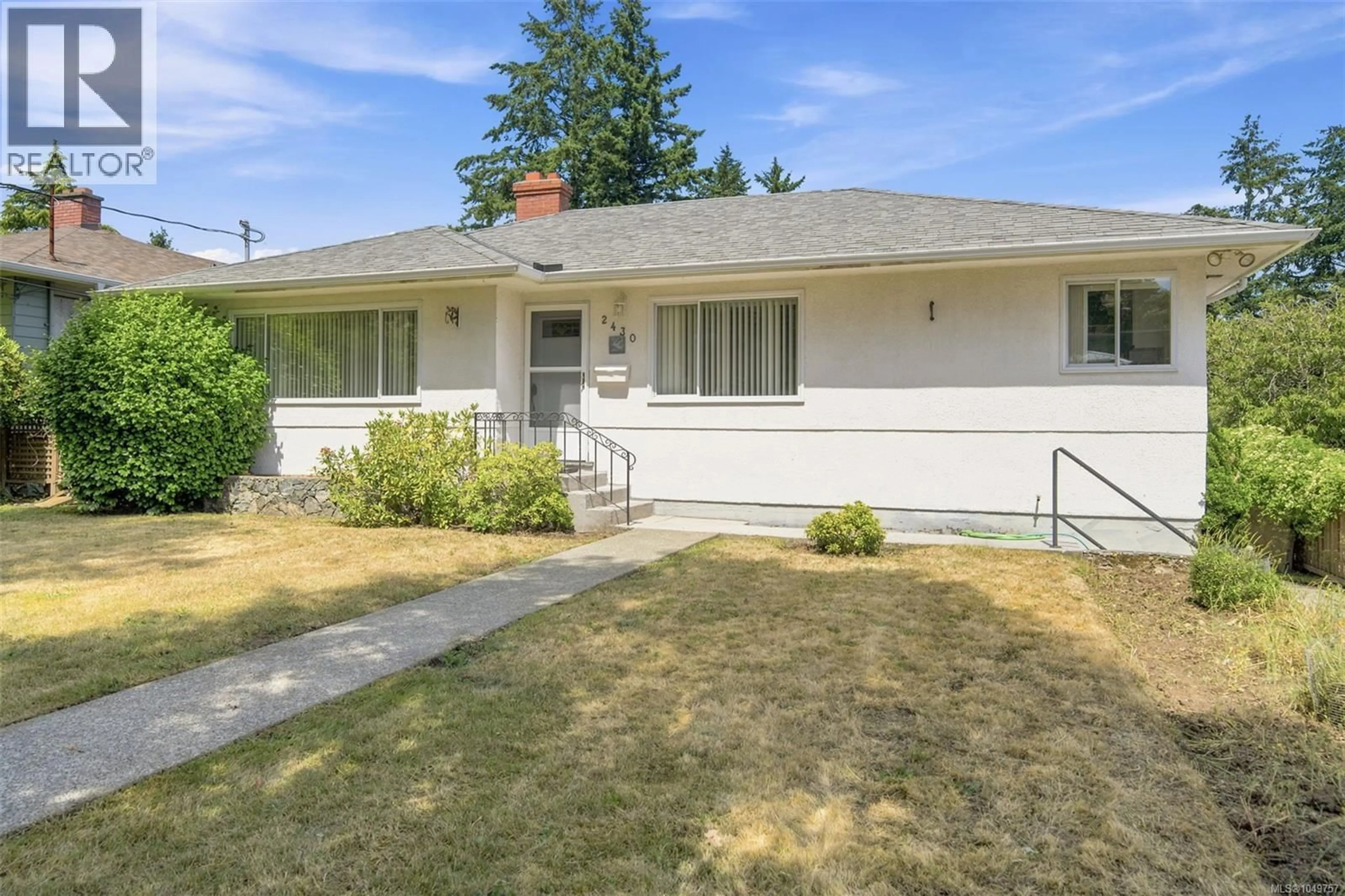 Home with vinyl exterior material, street for 2430 CAMELOT ROAD, Saanich British Columbia V8N1J3