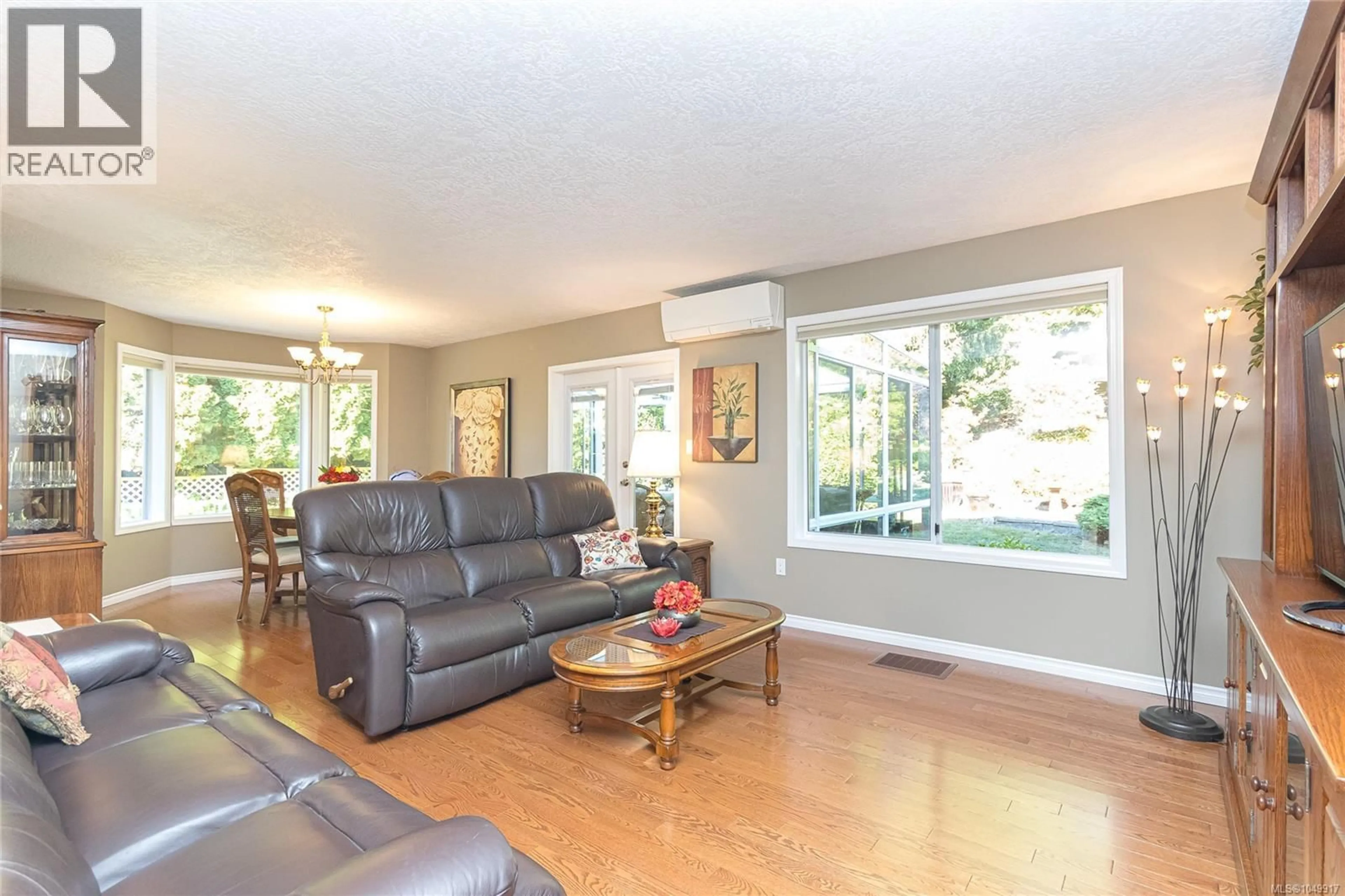 Living room with furniture, wood/laminate floor for 8571 KINGCOME CRESCENT, North Saanich British Columbia V8L5B8