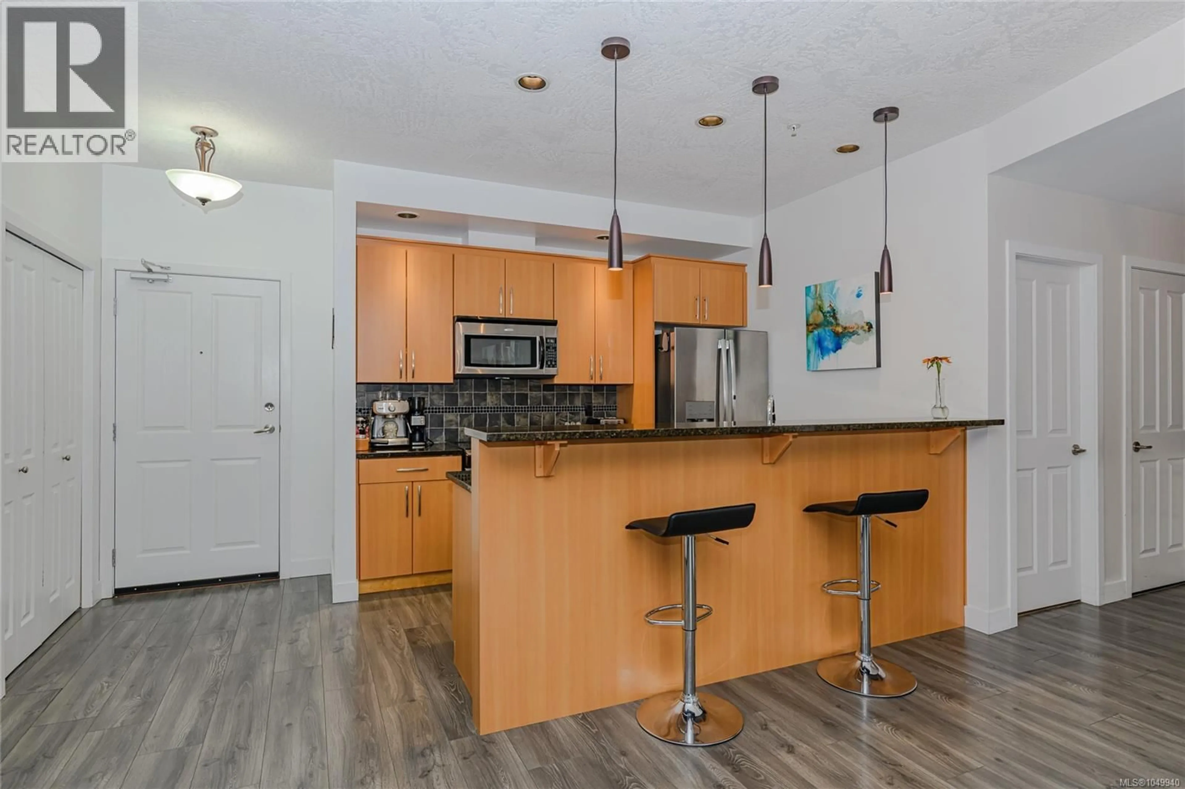 Open concept kitchen, wood/laminate floor for 406 - 623 TREANOR AVENUE, Langford British Columbia V9B0B1
