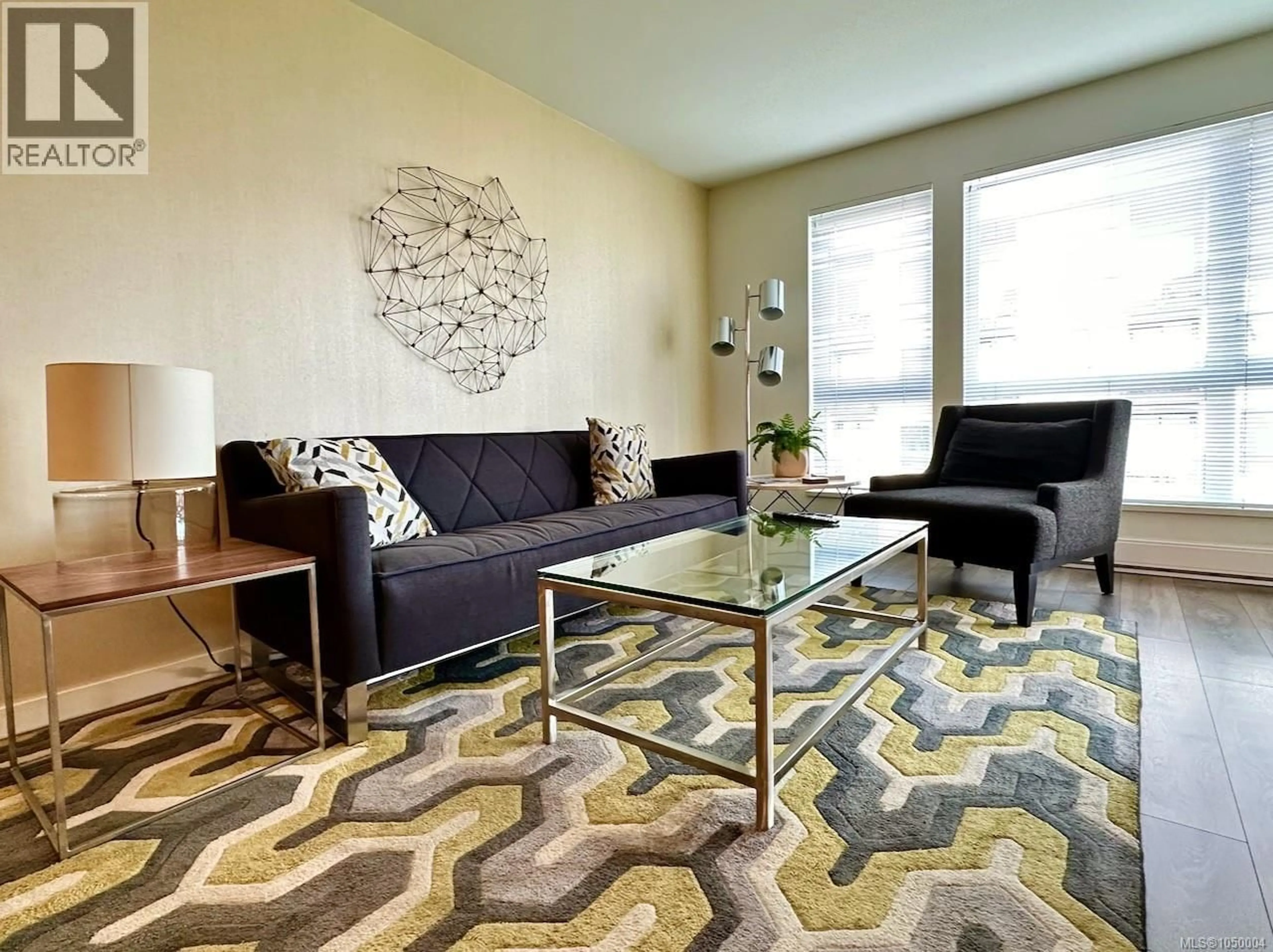 Living room with furniture, carpet floor for 408 - 528 PANDORA AVENUE, Victoria British Columbia V8W0C6