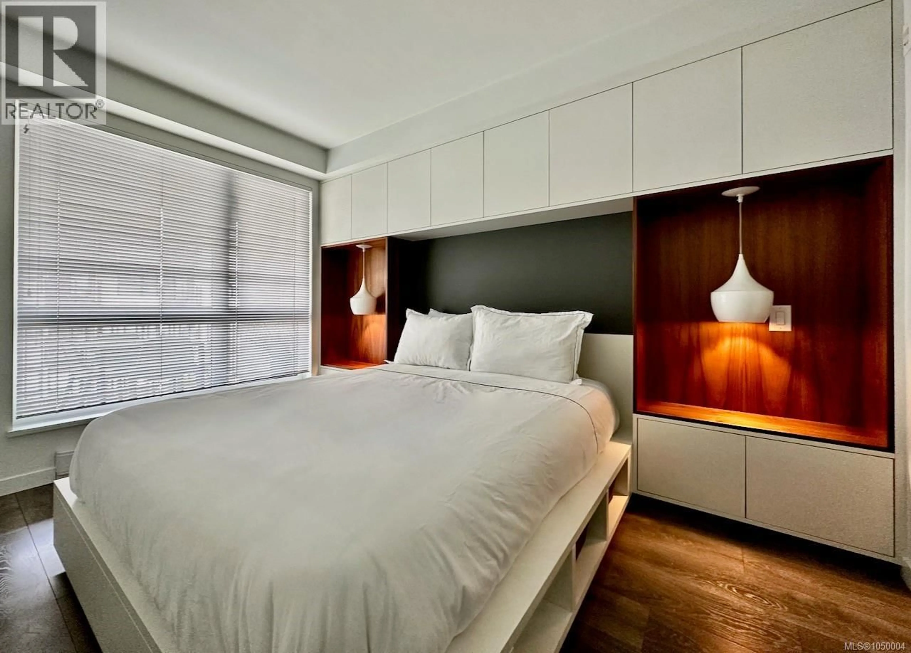 Bedroom with bed, wood/laminate floor for 408 - 528 PANDORA AVENUE, Victoria British Columbia V8W0C6