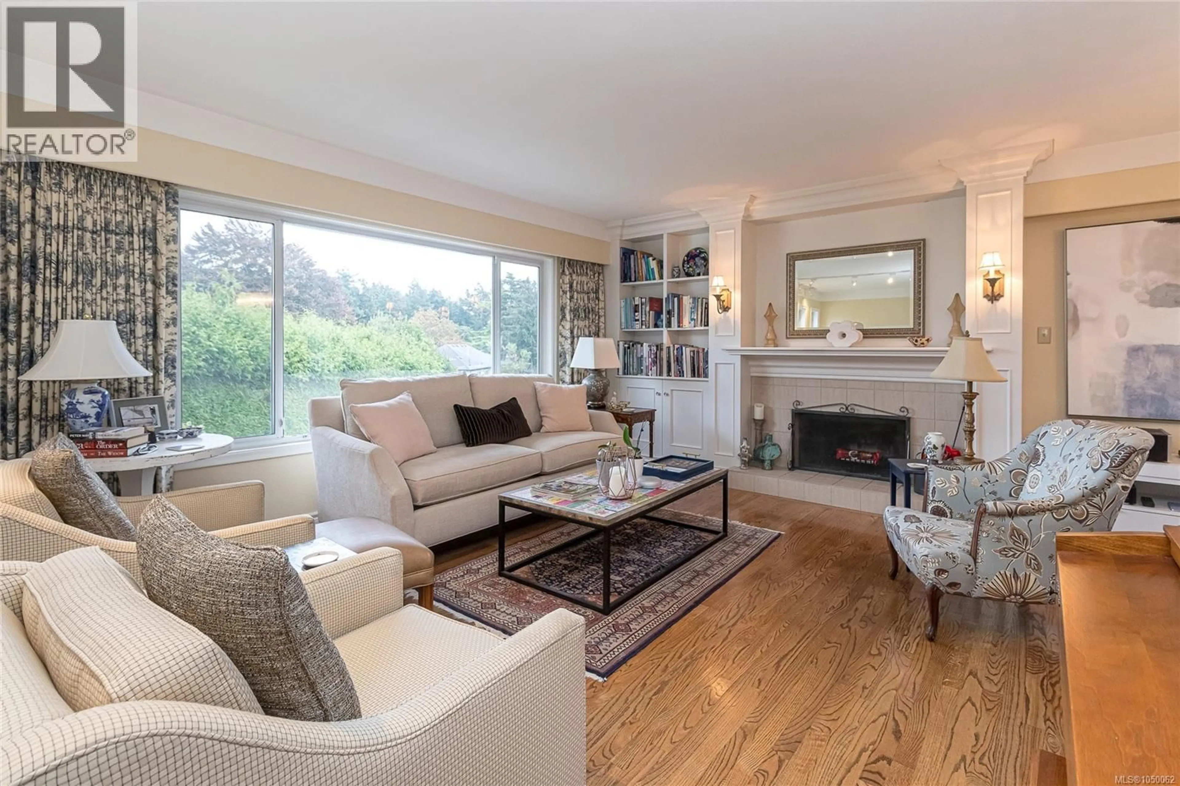 Living room with furniture, wood/laminate floor for 3884 FINNERTY ROAD, Saanich British Columbia V8N4A2