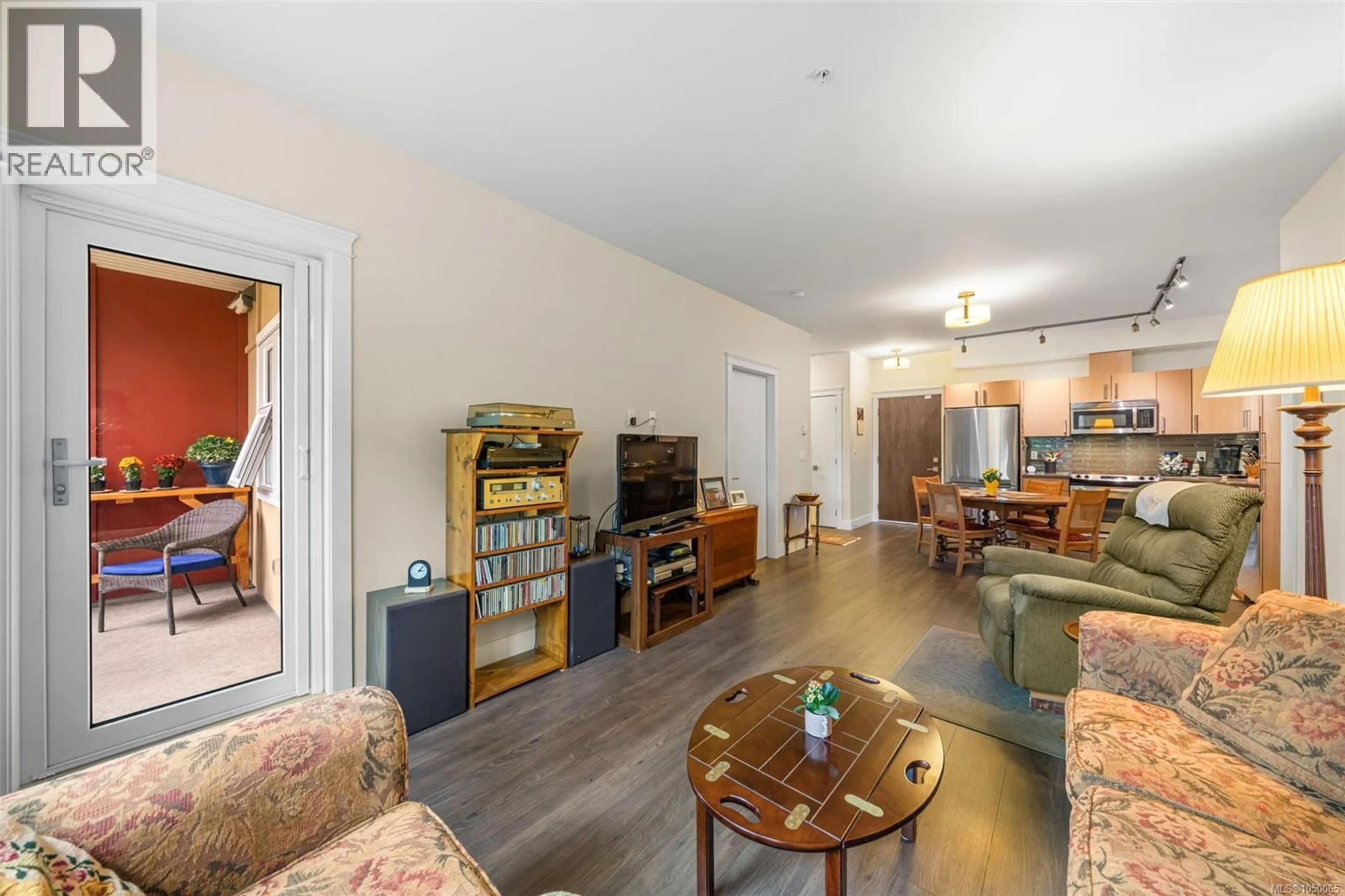 Living room with furniture, wood/laminate floor for 306 - 1900 WATKISS WAY, View Royal British Columbia V9B0S8