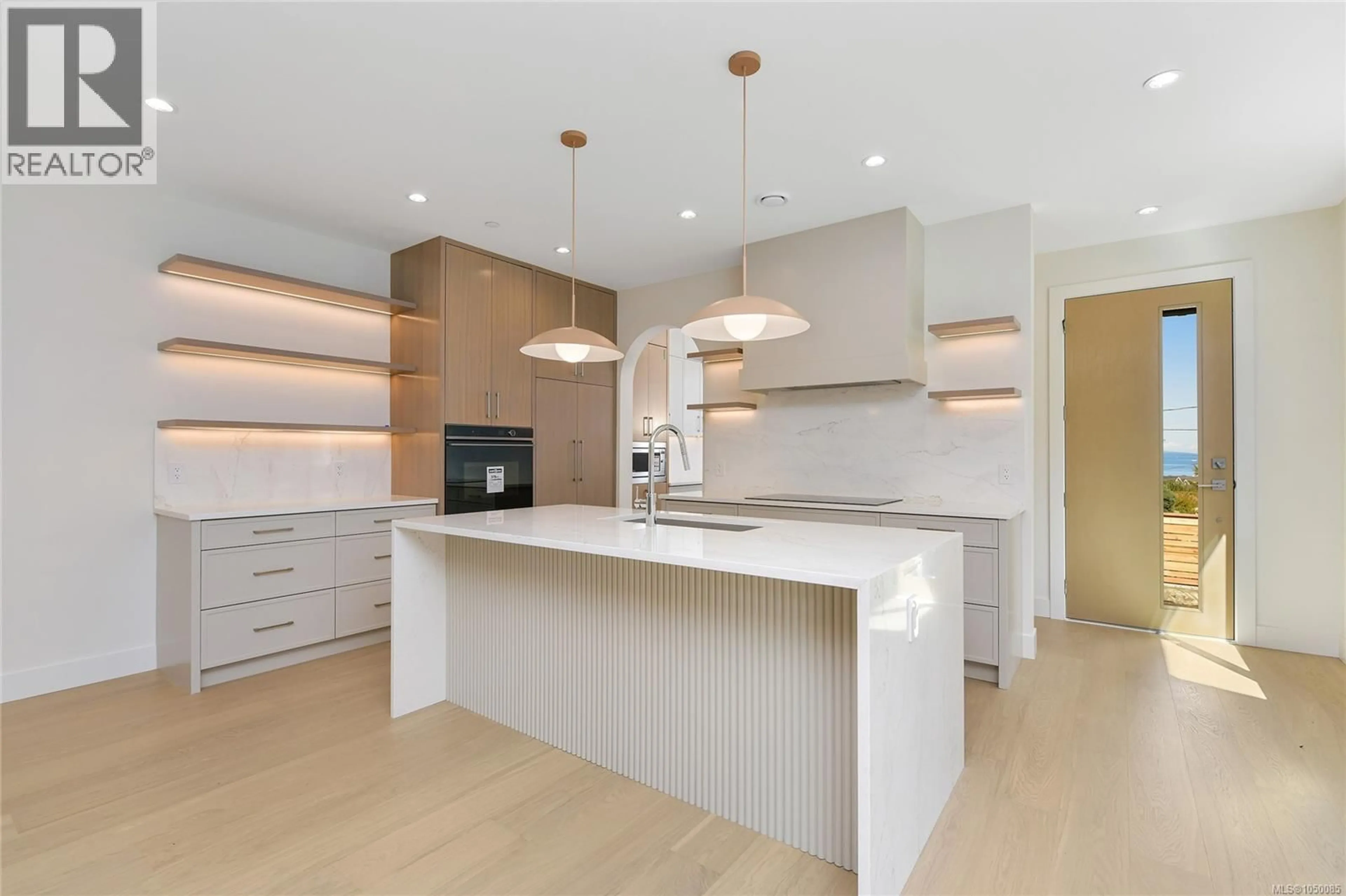 Open concept kitchen, wood/laminate floor for 1 - 4430 SHORE WAY, Saanich British Columbia V8N3T9