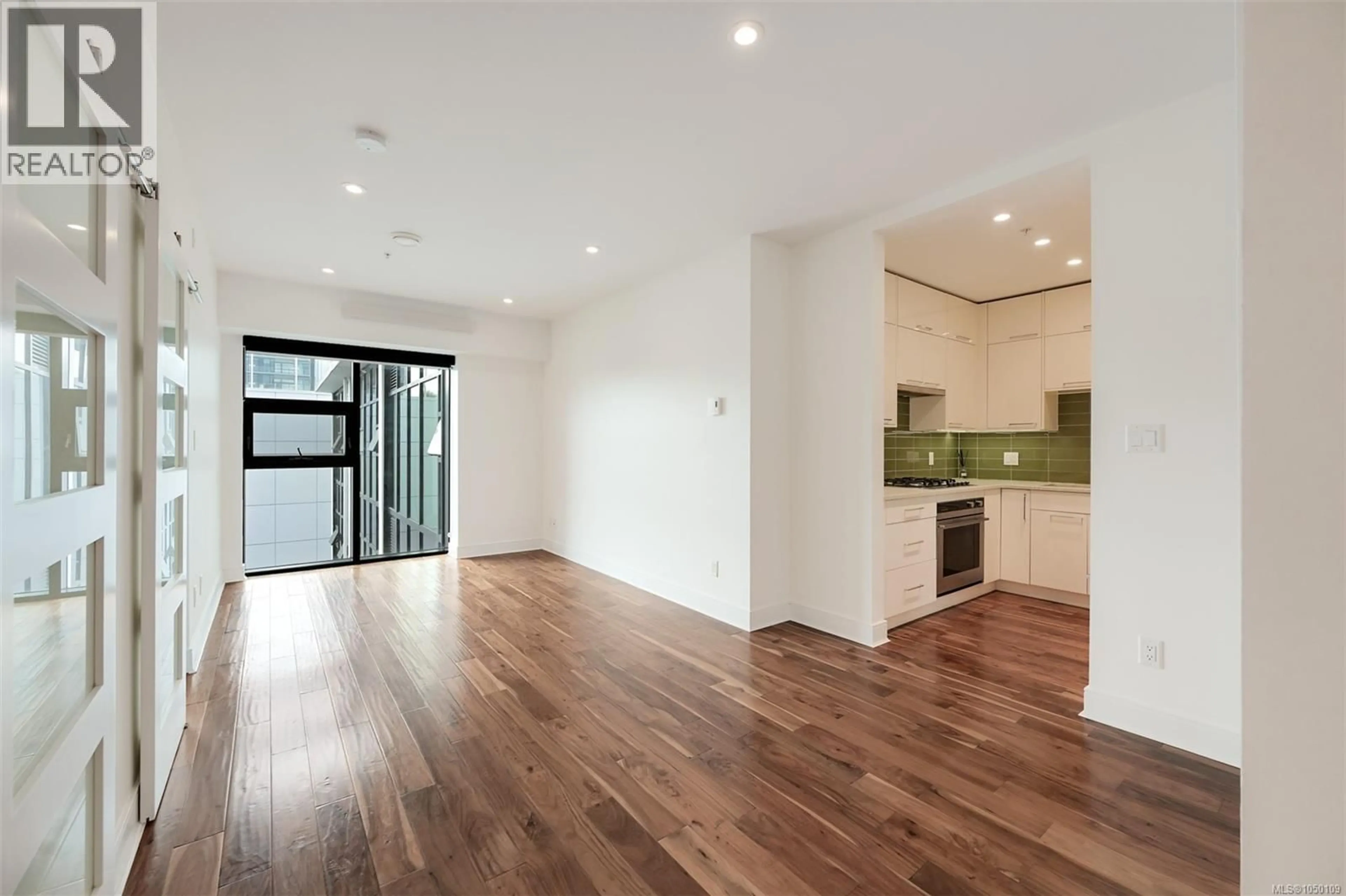 Open concept kitchen, wood/laminate floor for N414 - 1105 PANDORA AVENUE, Victoria British Columbia V8V3P9
