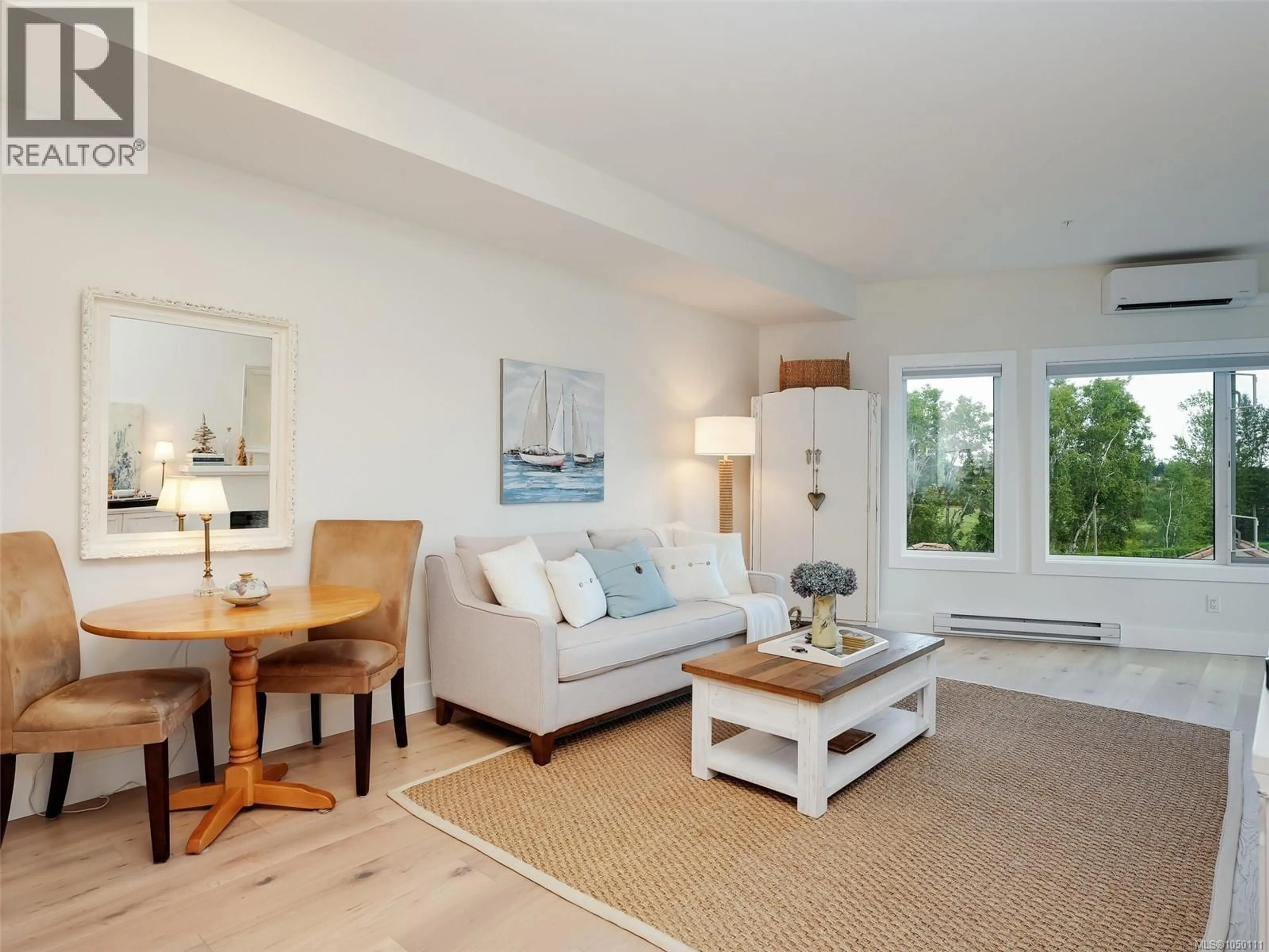 Living room with furniture, wood/laminate floor for 308 - 7098 WALLACE DRIVE, Central Saanich British Columbia V8M1G9