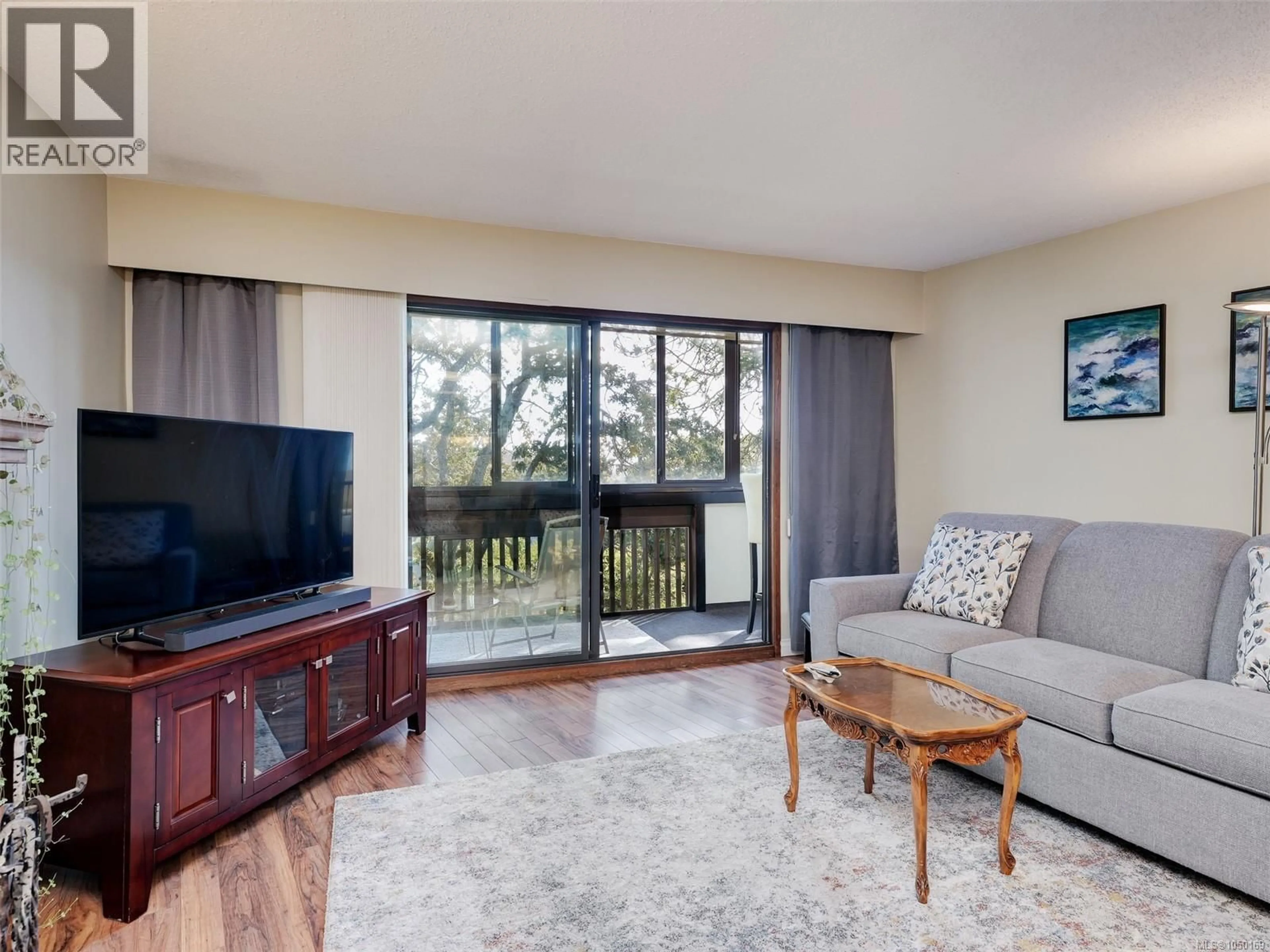 Living room with furniture, wood/laminate floor for 312 - 3962 CEDAR HILL ROAD, Saanich British Columbia V8N3B8