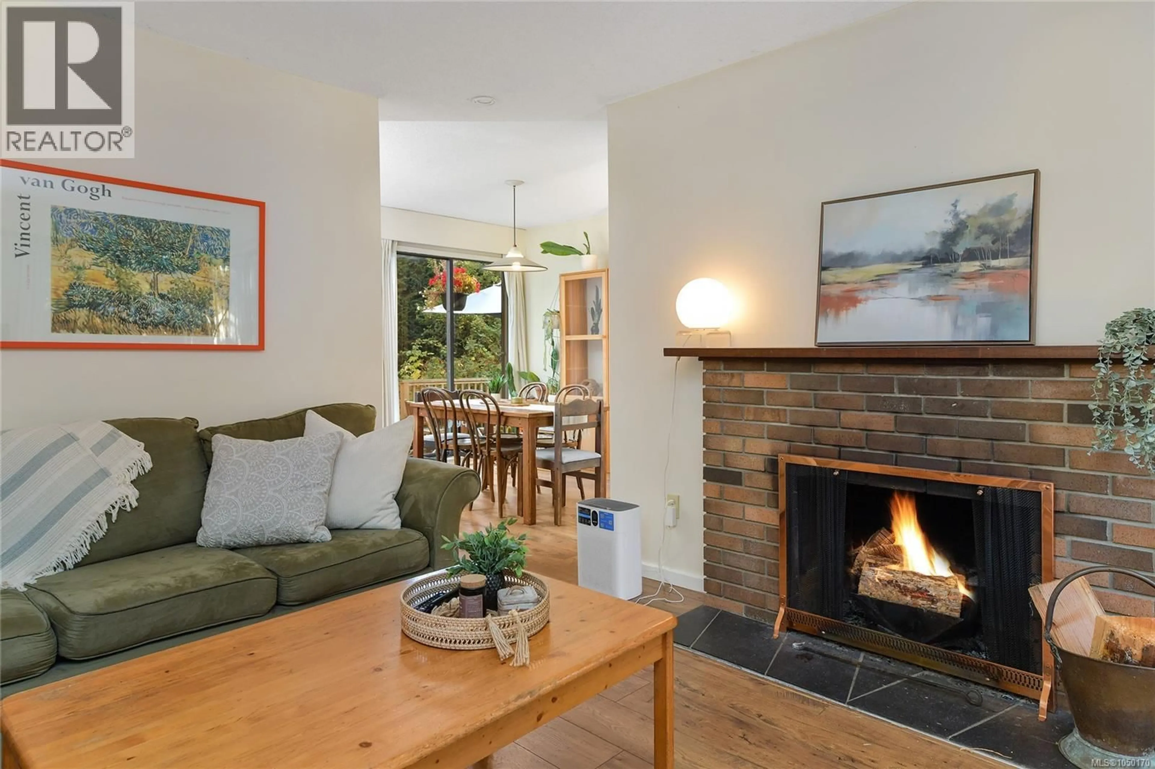 Living room with furniture, wood/laminate floor for 4039 DAFFODIL PLACE, Saanich British Columbia V8Z6G1