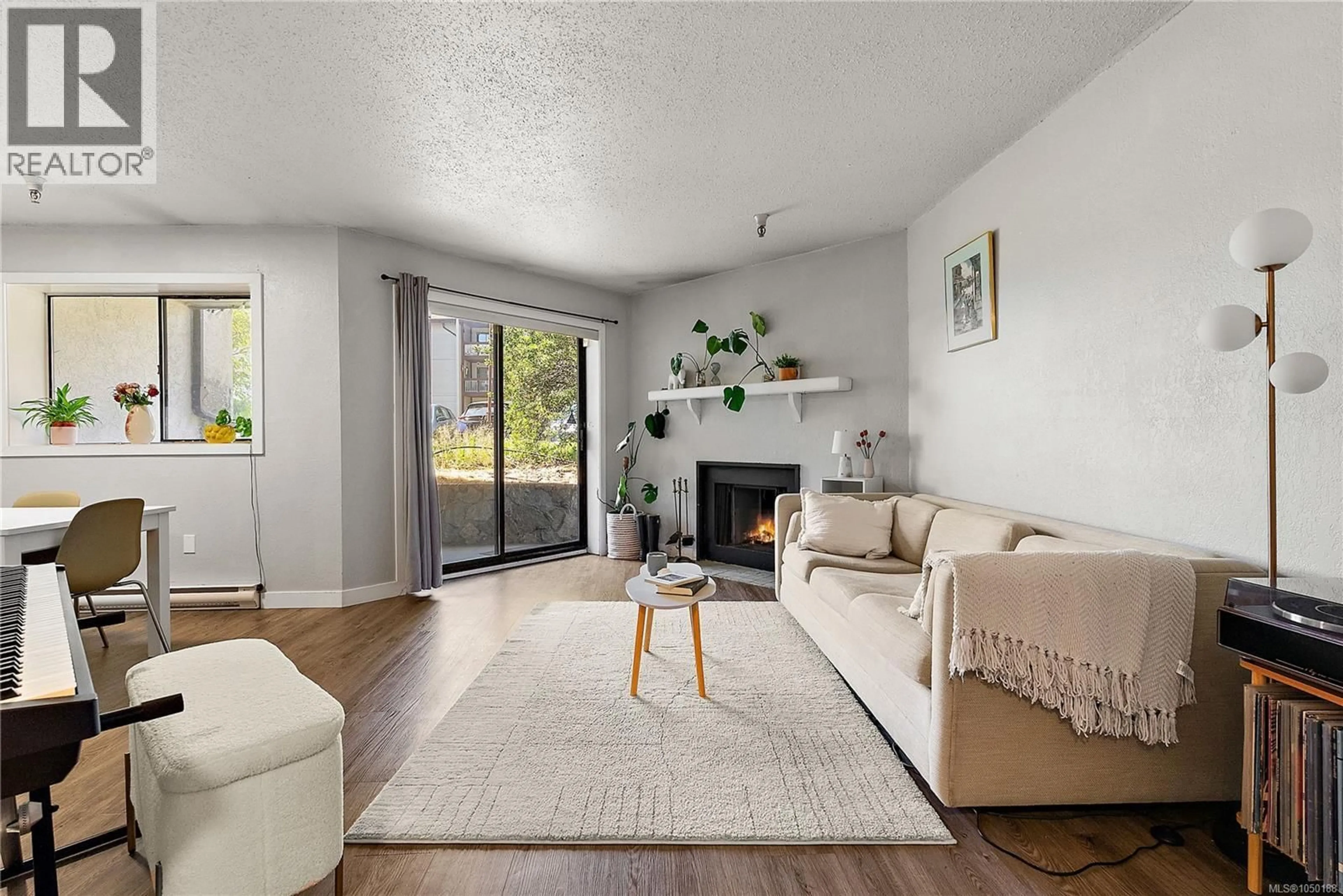 Living room with furniture, wood/laminate floor for 106 - 71 GORGE ROAD WEST, Saanich British Columbia V9A1L9