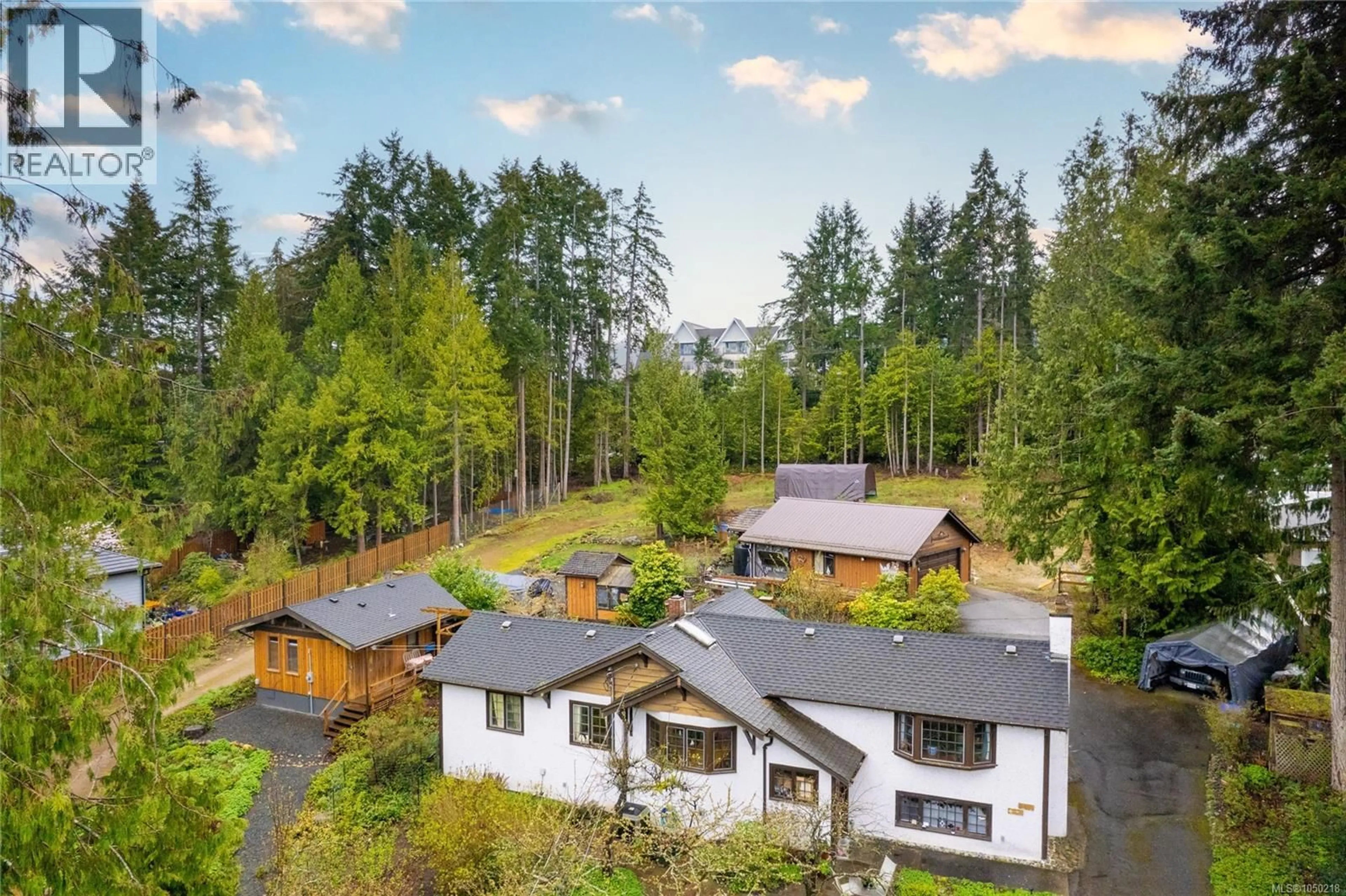 A pic from outside/outdoor area/front of a property/back of a property/a pic from drone, forest/trees view for 218 SUNNINGDALE ROAD EAST, Qualicum Beach British Columbia V9K1L3