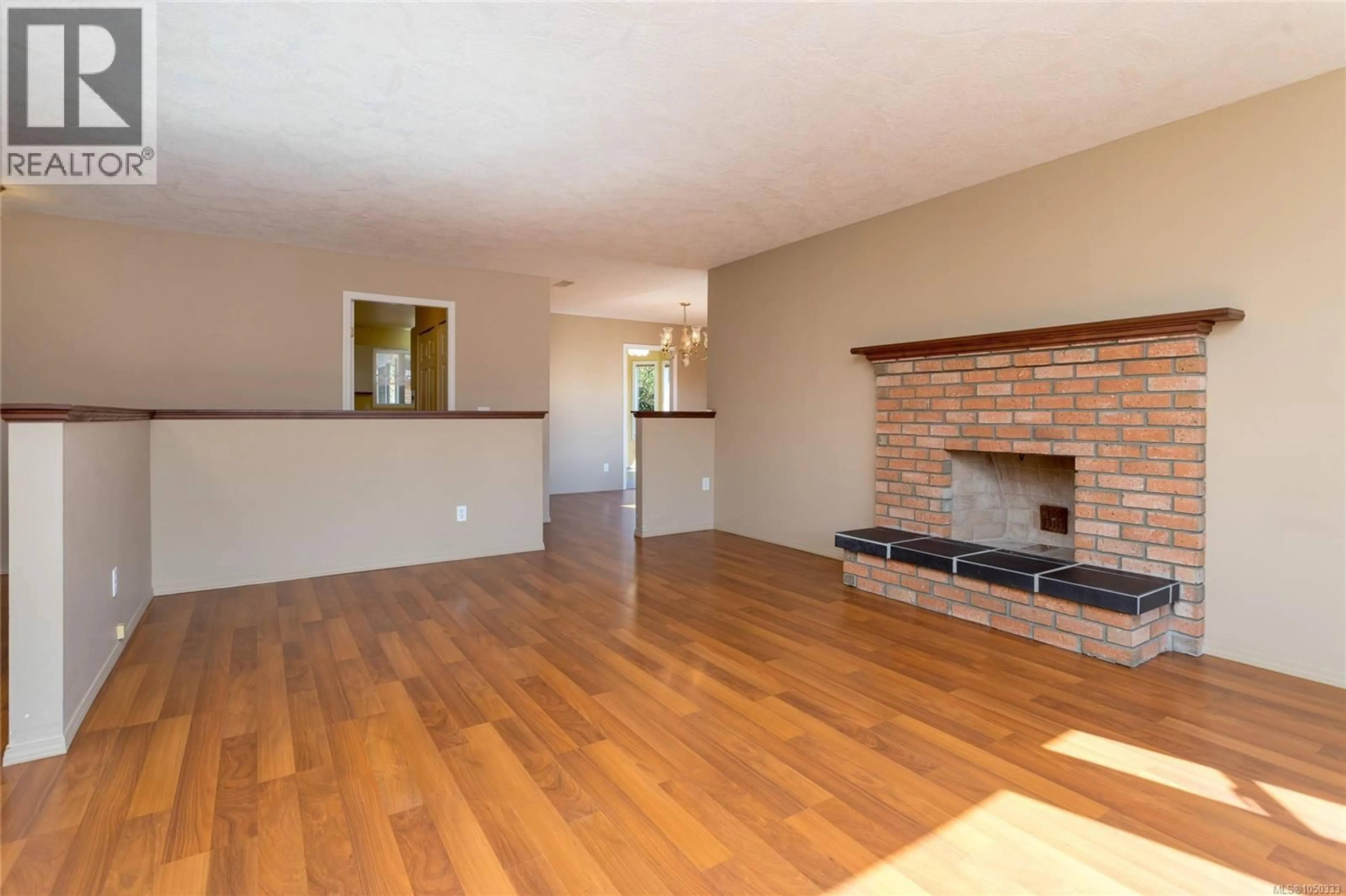 Living room with furniture, wood/laminate floor for 2128 COLINWOOD ROAD, Sidney British Columbia V8L4H5