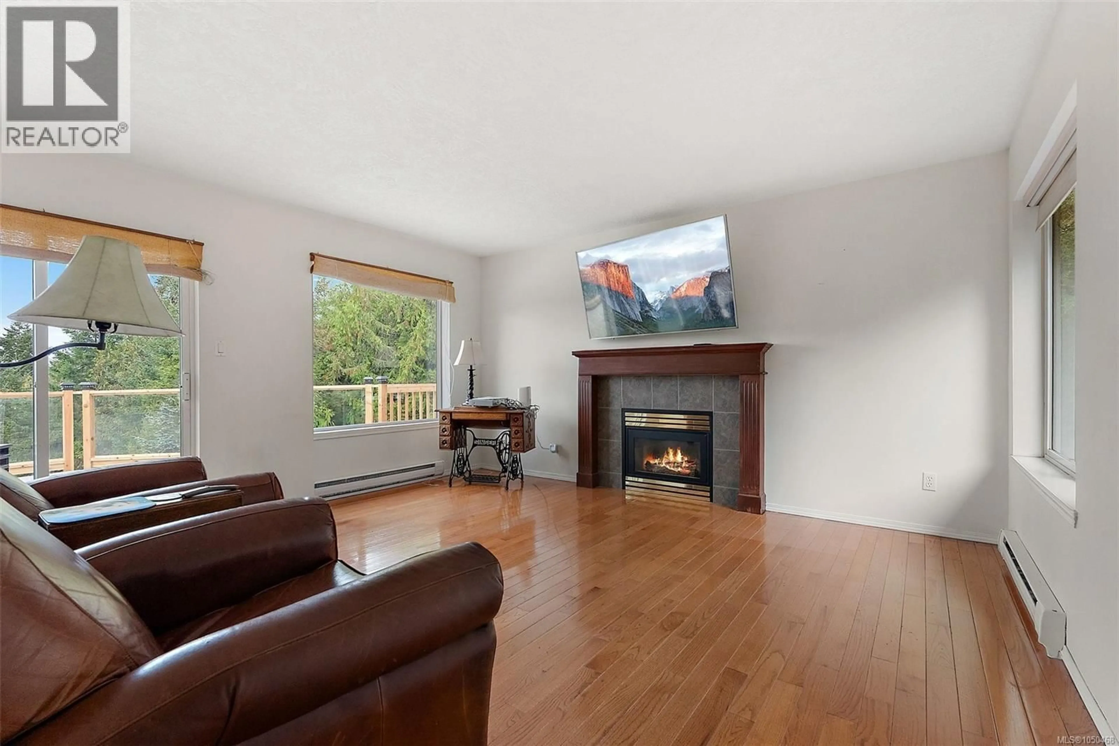Living room with furniture, wood/laminate floor for 6791 EAST SOOKE ROAD, Sooke British Columbia V9Z1A6