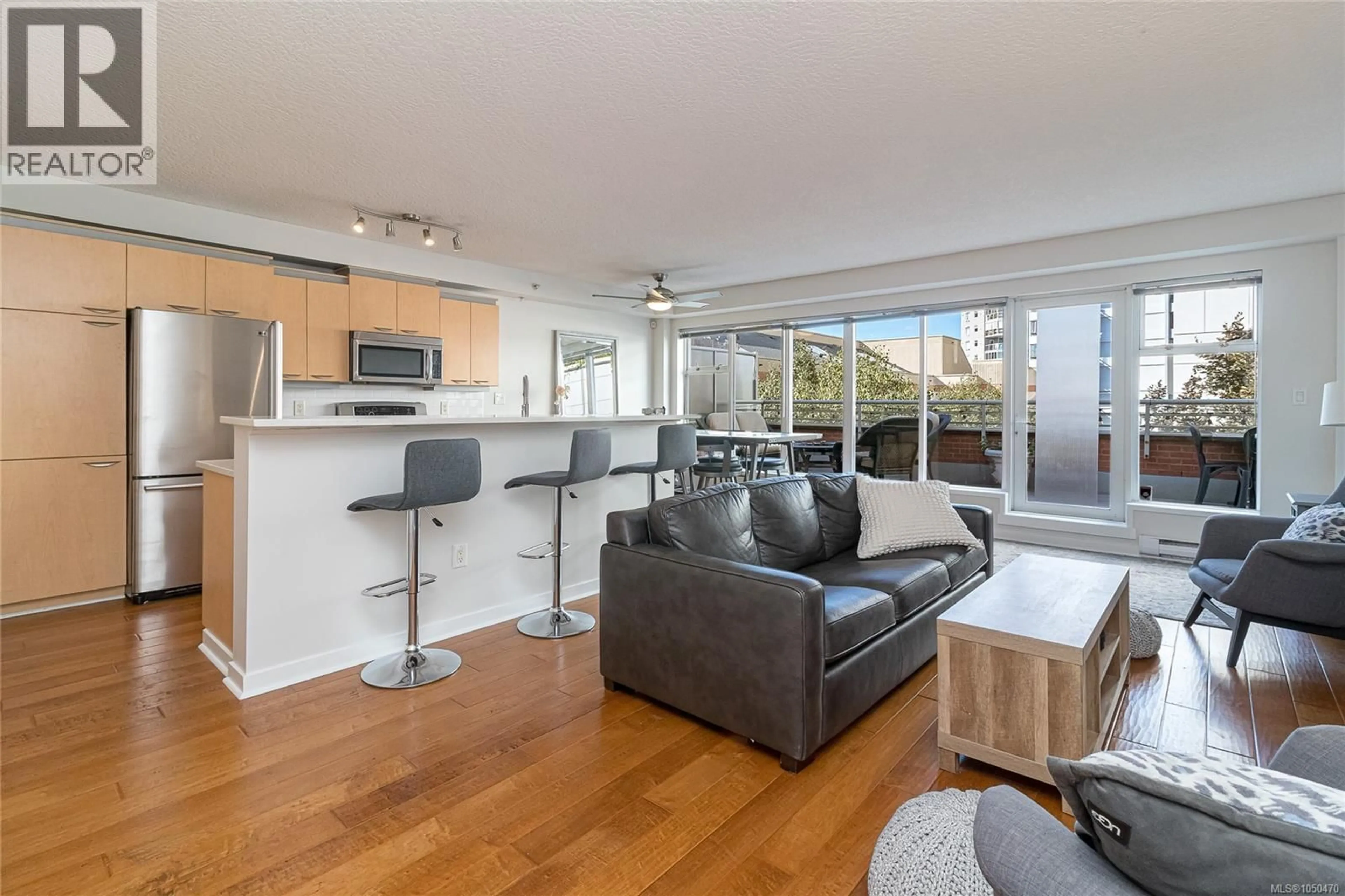 Living room with furniture, wood/laminate floor for 505 - 1030 YATES STREET, Victoria British Columbia V8V5A7