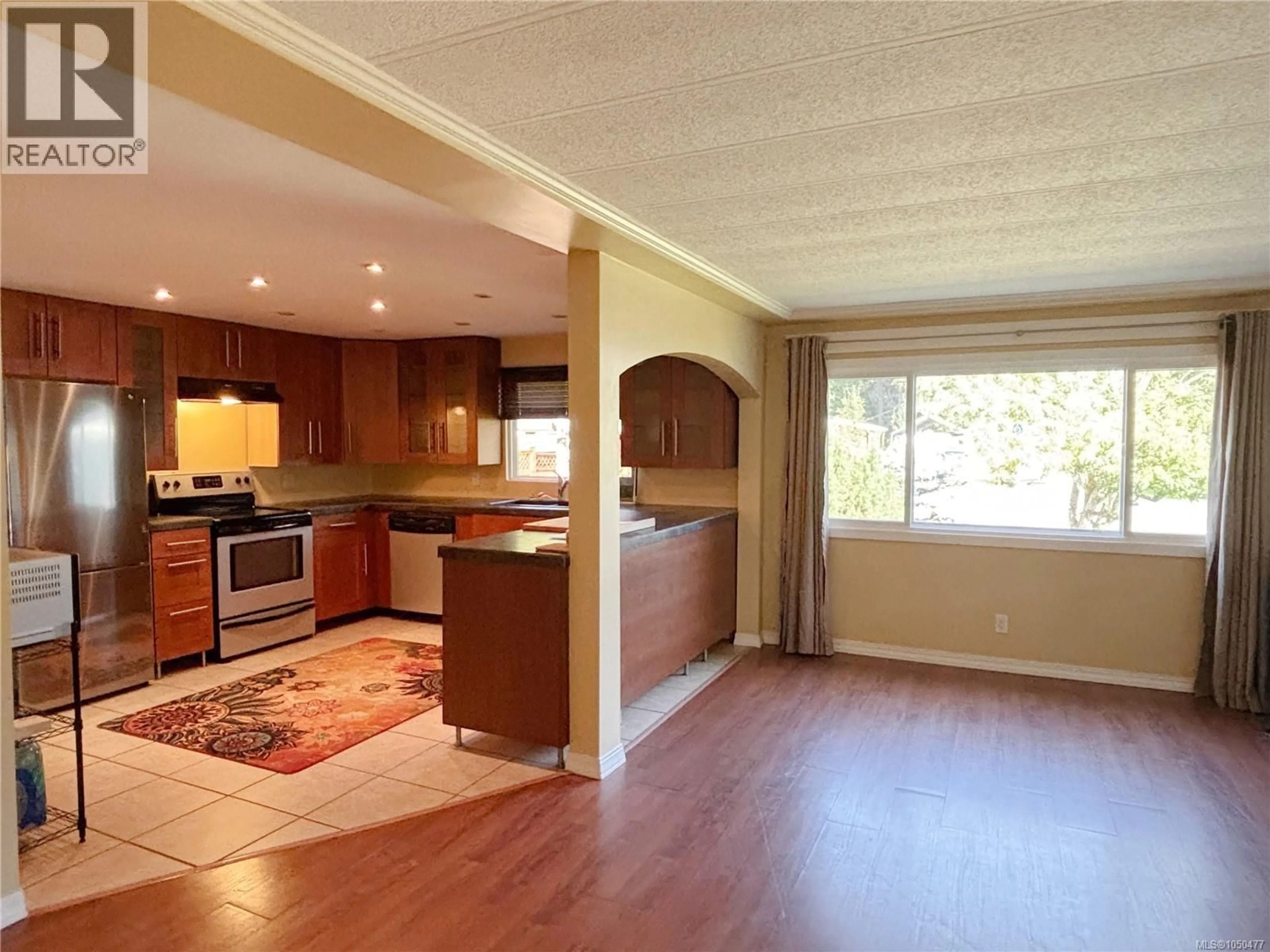 Open concept kitchen, wood/laminate floor for 603 CONUMA DRIVE, Gold River British Columbia V0P1G0