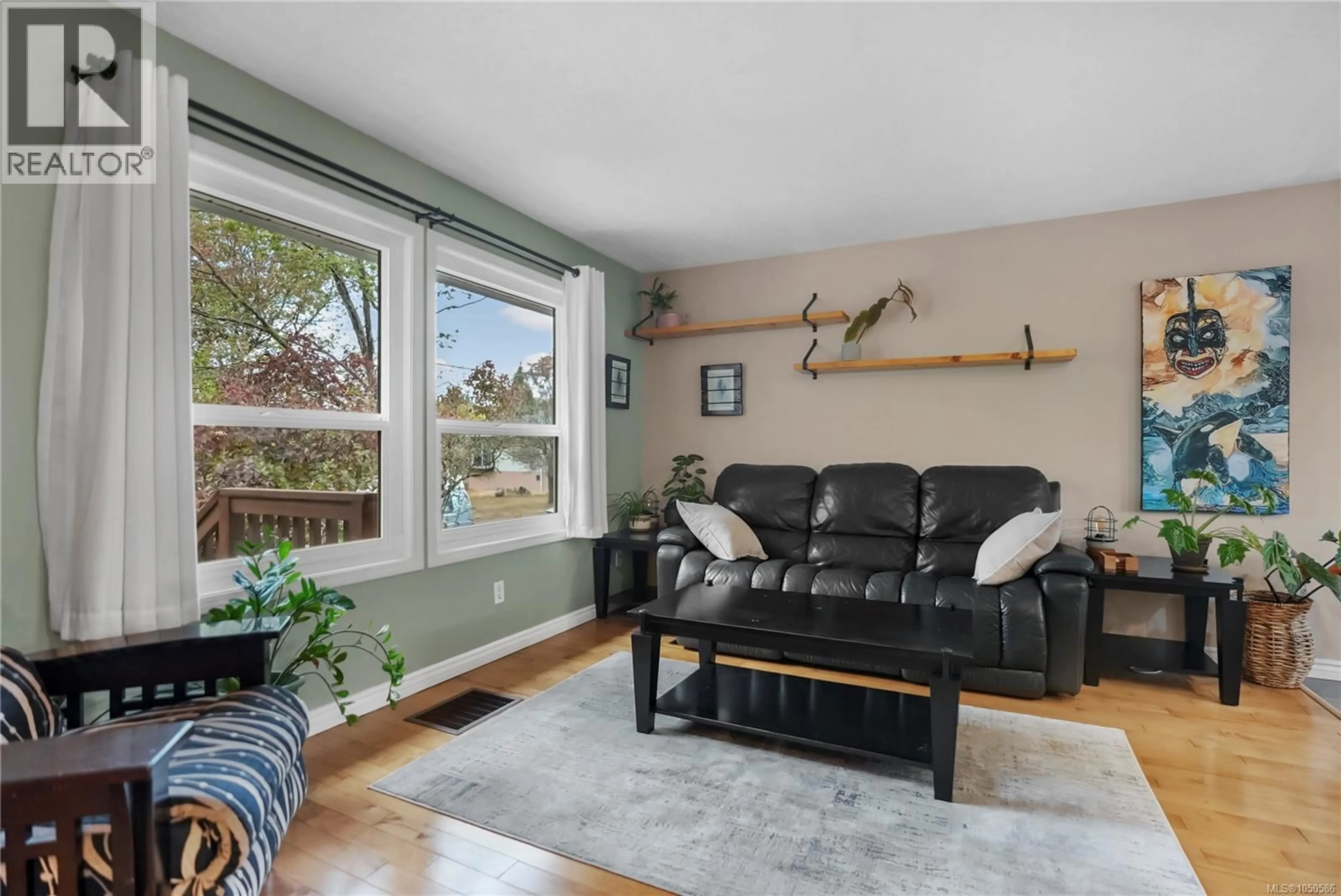 Living room with furniture, wood/laminate floor for 2539 CEDAR HILL ROAD, Victoria British Columbia V8T3G8