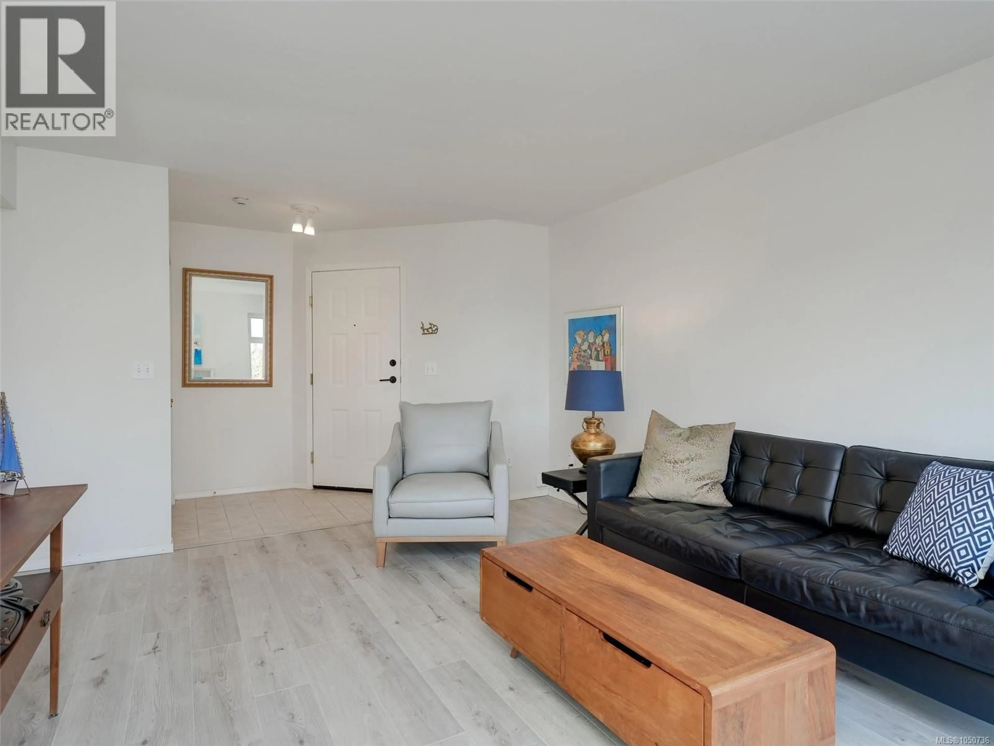 Living room with furniture, wood/laminate floor for 301 - 837 SELKIRK AVENUE, Esquimalt British Columbia V9A2T7