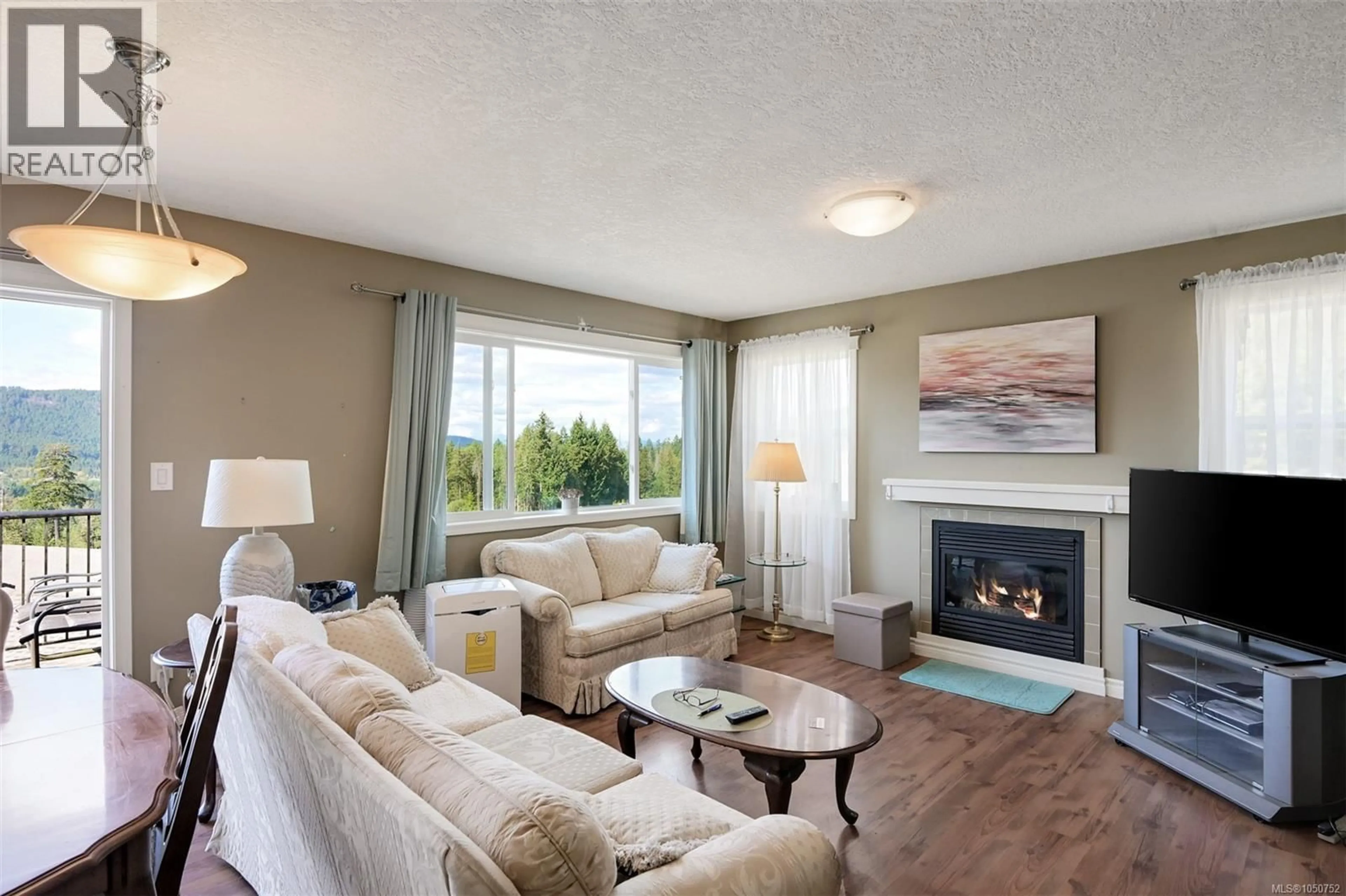 Living room with furniture, wood/laminate floor for 1069 FITZGERALD ROAD, Shawnigan Lake British Columbia V8H2H8