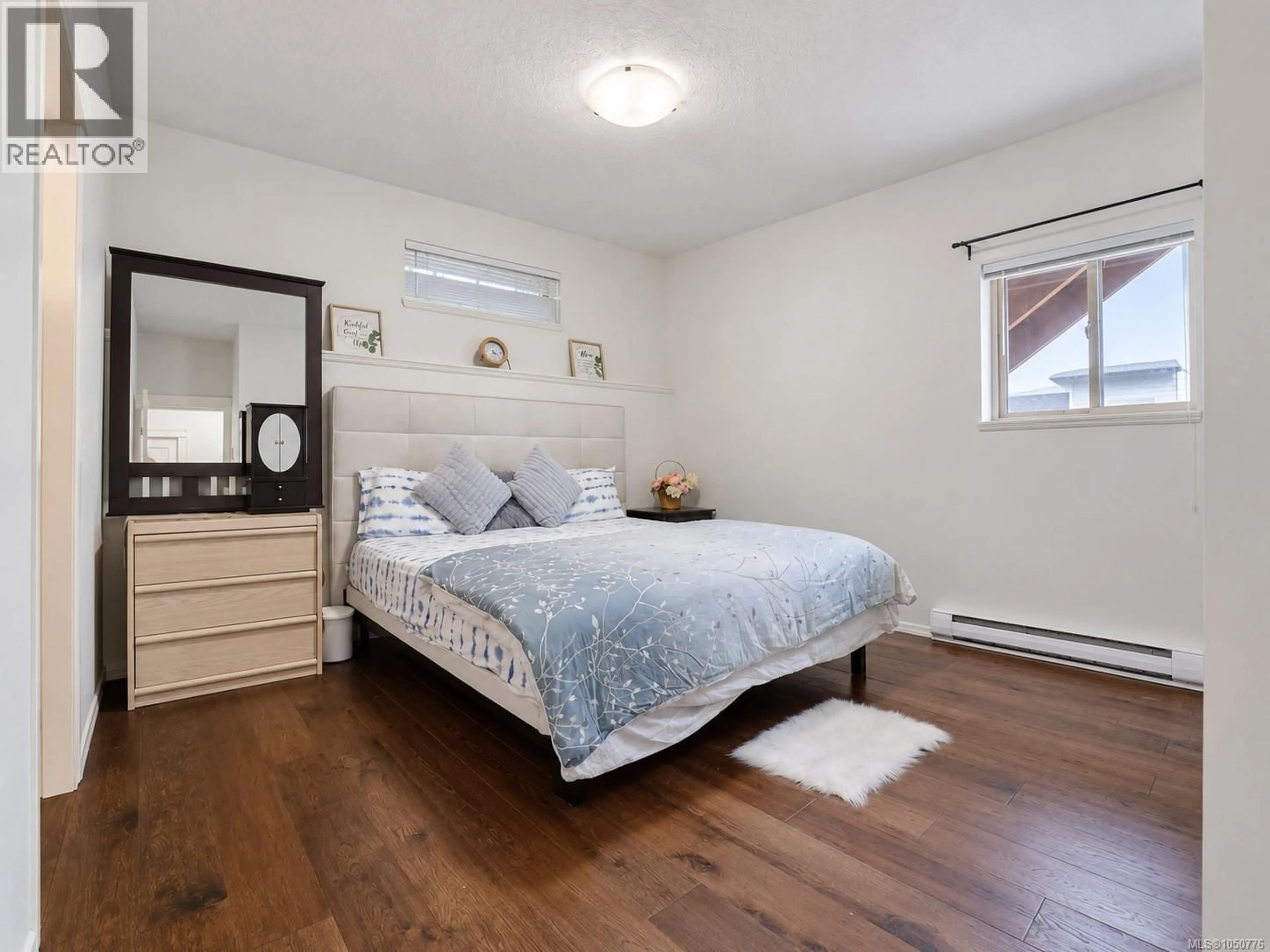 Bedroom with bed, wood/laminate floor for 107 - 791 STATION AVENUE, Langford British Columbia V9B0E6