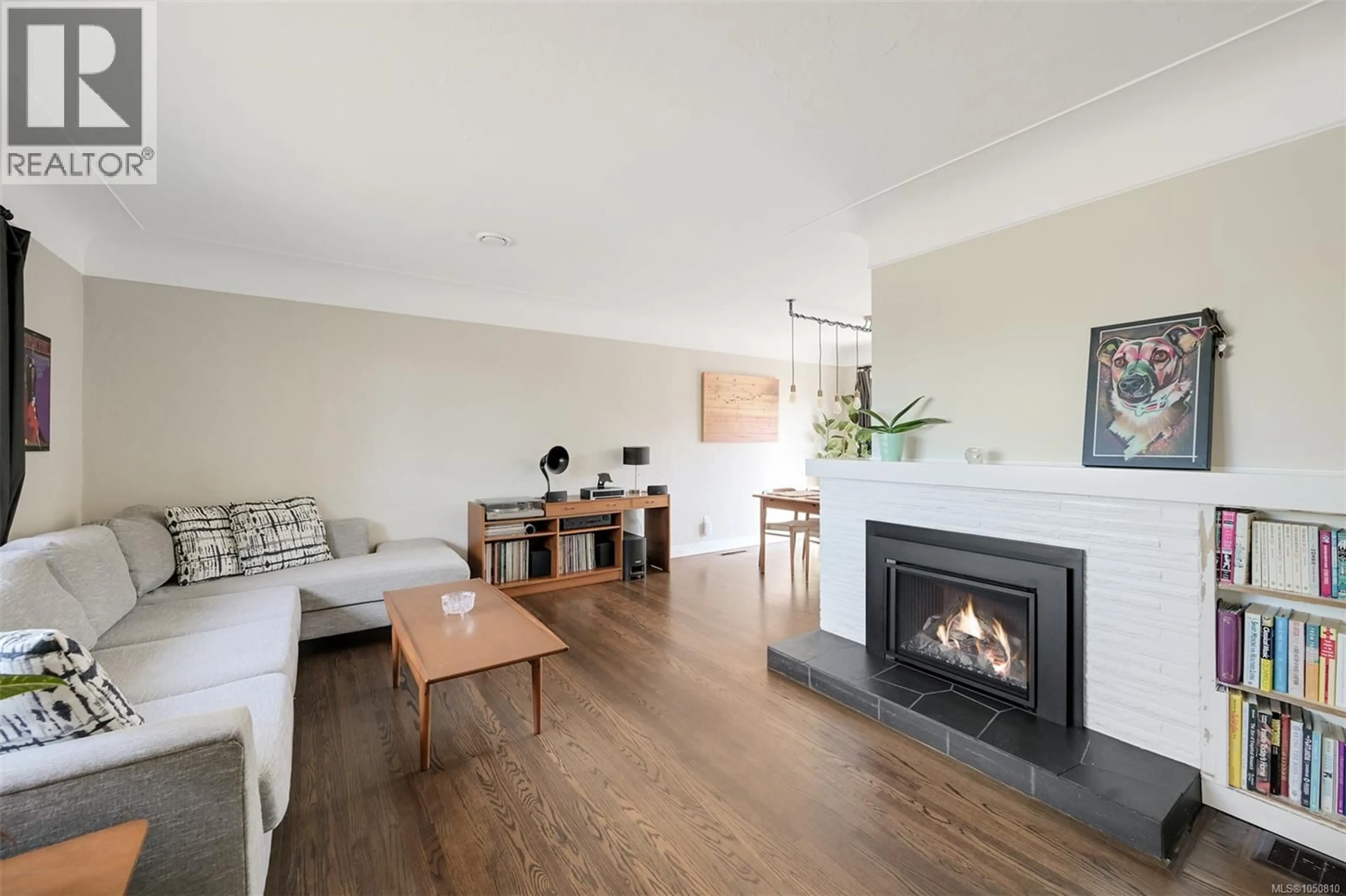 Living room with furniture, wood/laminate floor for 3221 SERVICE STREET, Saanich British Columbia V8P4M8