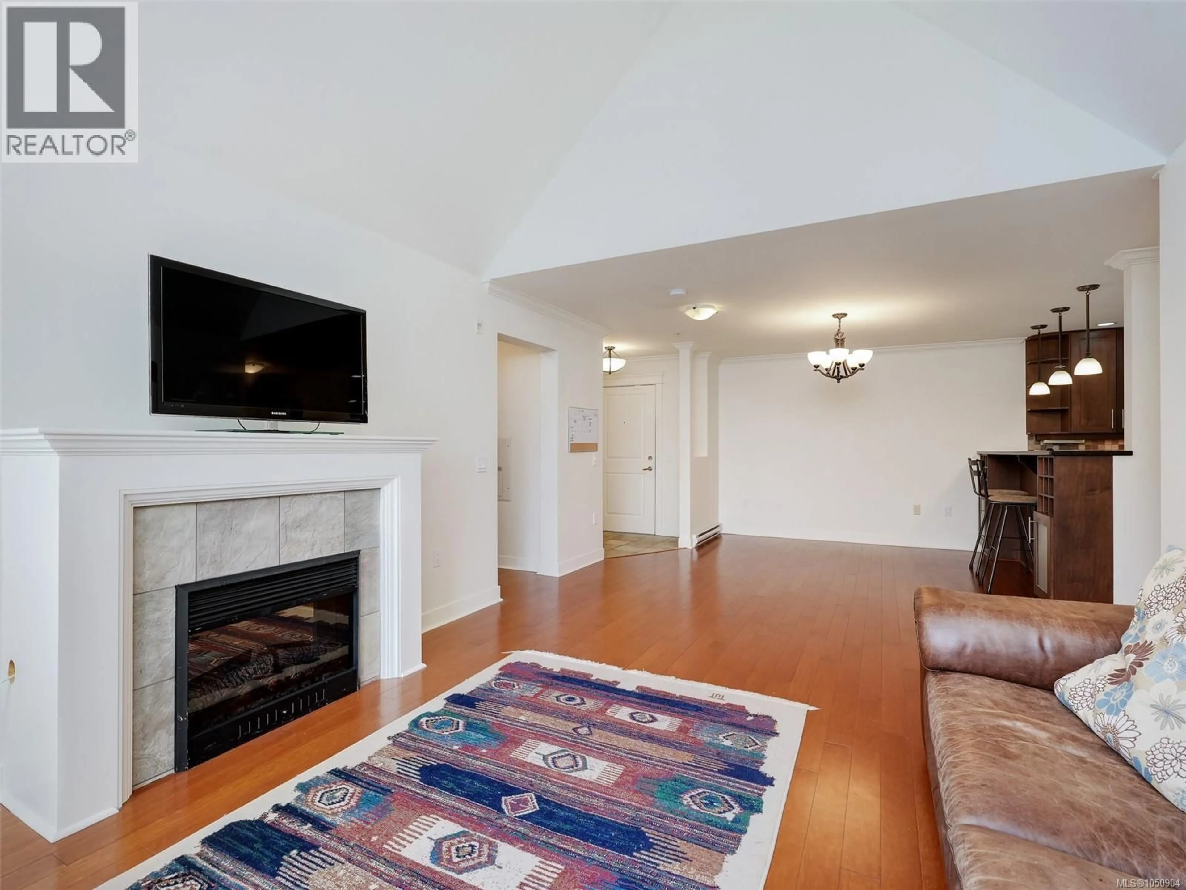 Living room with furniture, wood/laminate floor for 308 - 537 HEATHERDALE LANE, Saanich British Columbia V8Z0A4