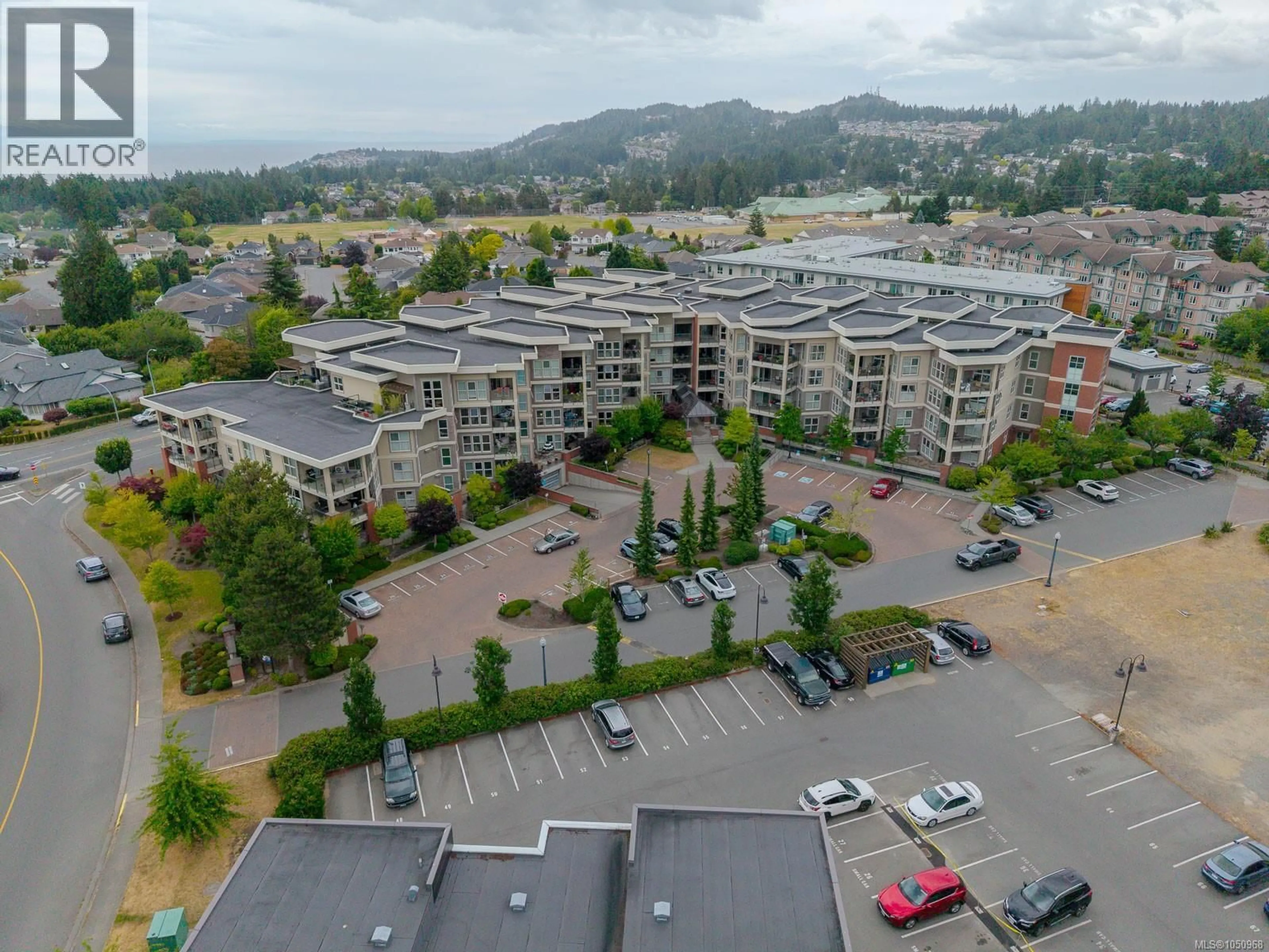 A pic from outside/outdoor area/front of a property/back of a property/a pic from drone, mountain view for 416 - 6310 MCROBB AVENUE, Nanaimo British Columbia V9V1W8