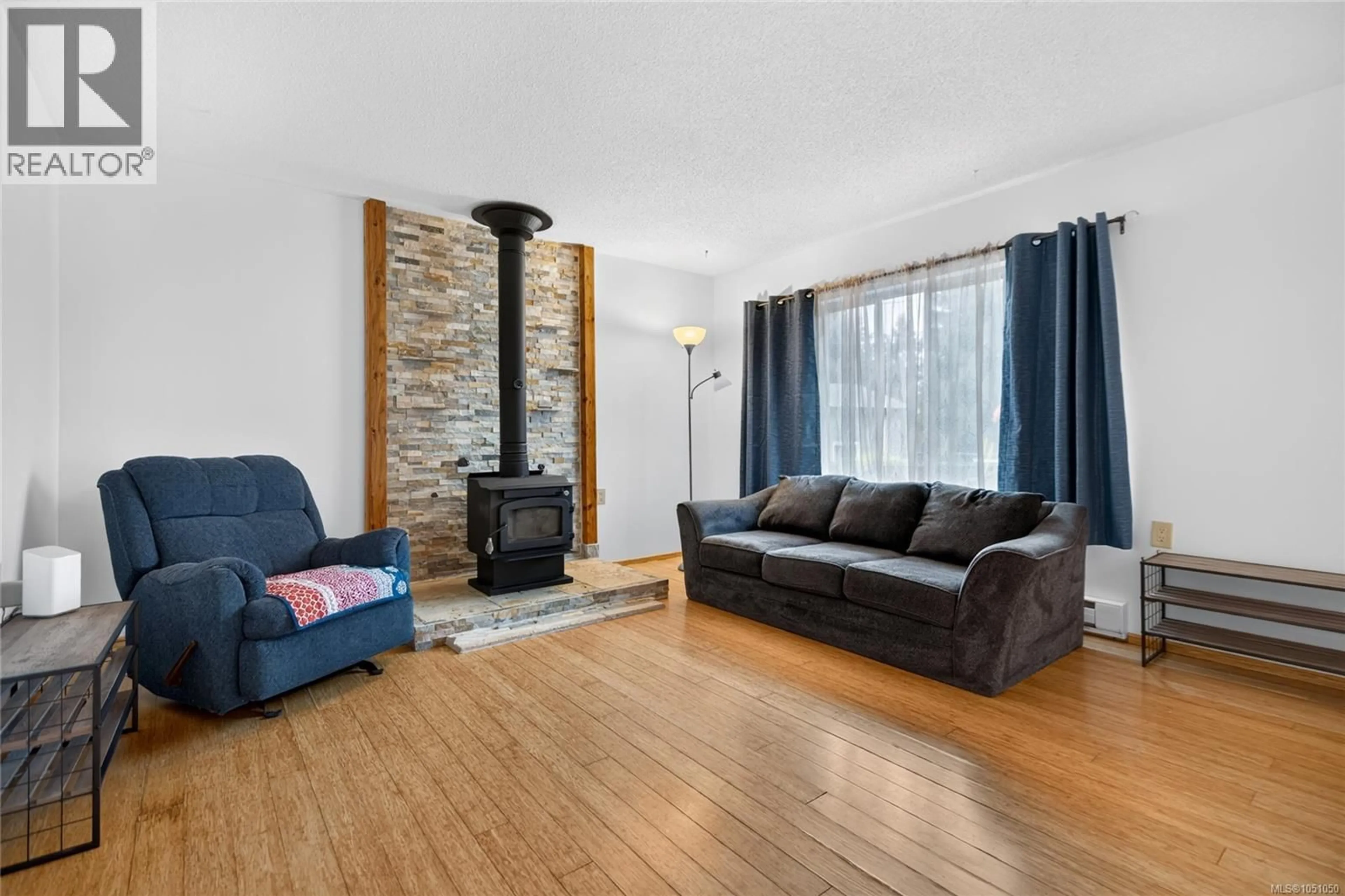 Living room with furniture, wood/laminate floor for 7842 TOZER ROAD, Fanny Bay British Columbia V0R1W0