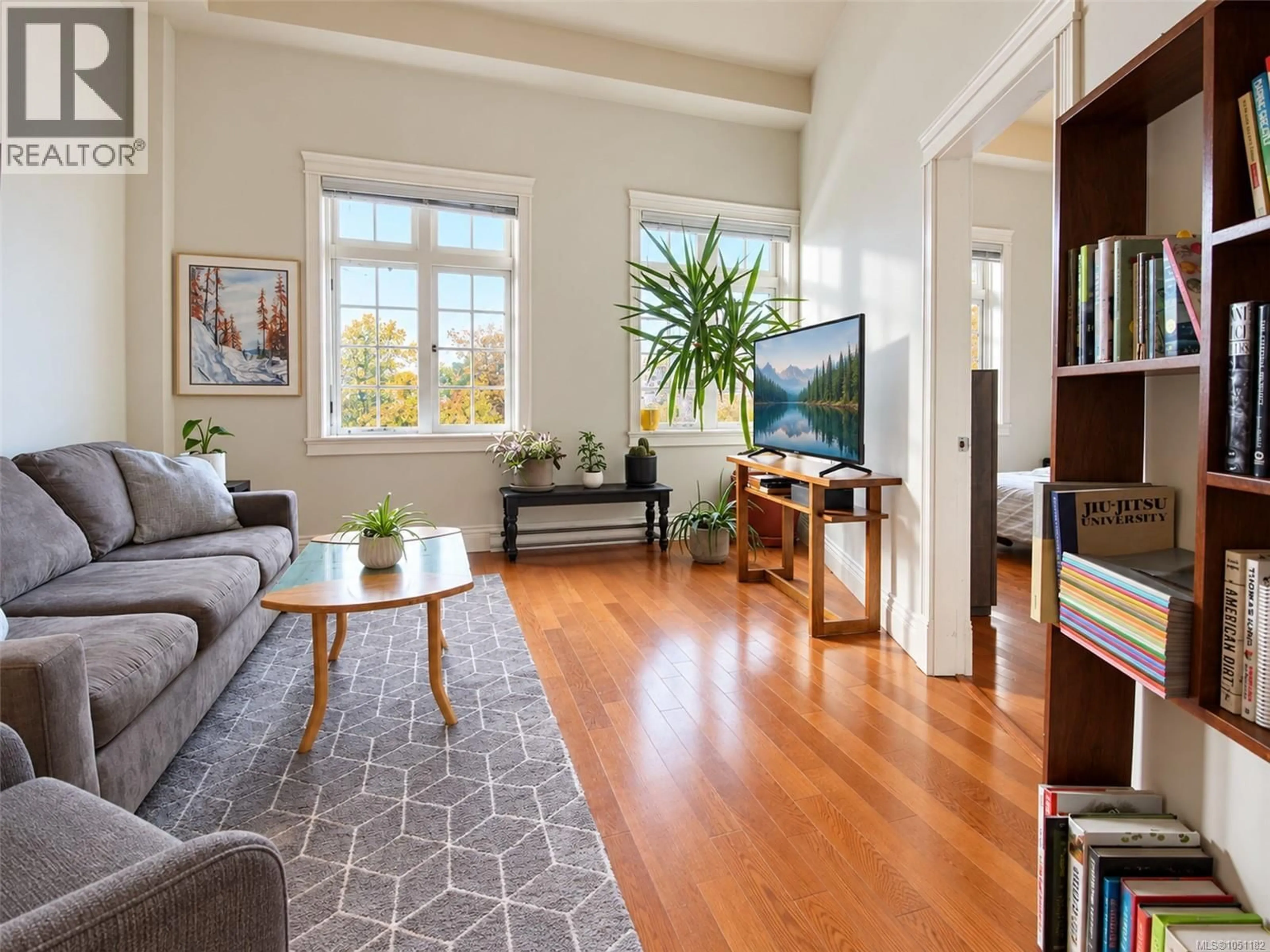 Living room with furniture, wood/laminate floor for 407 - 1602 QUADRA STREET, Victoria British Columbia V8W2L4