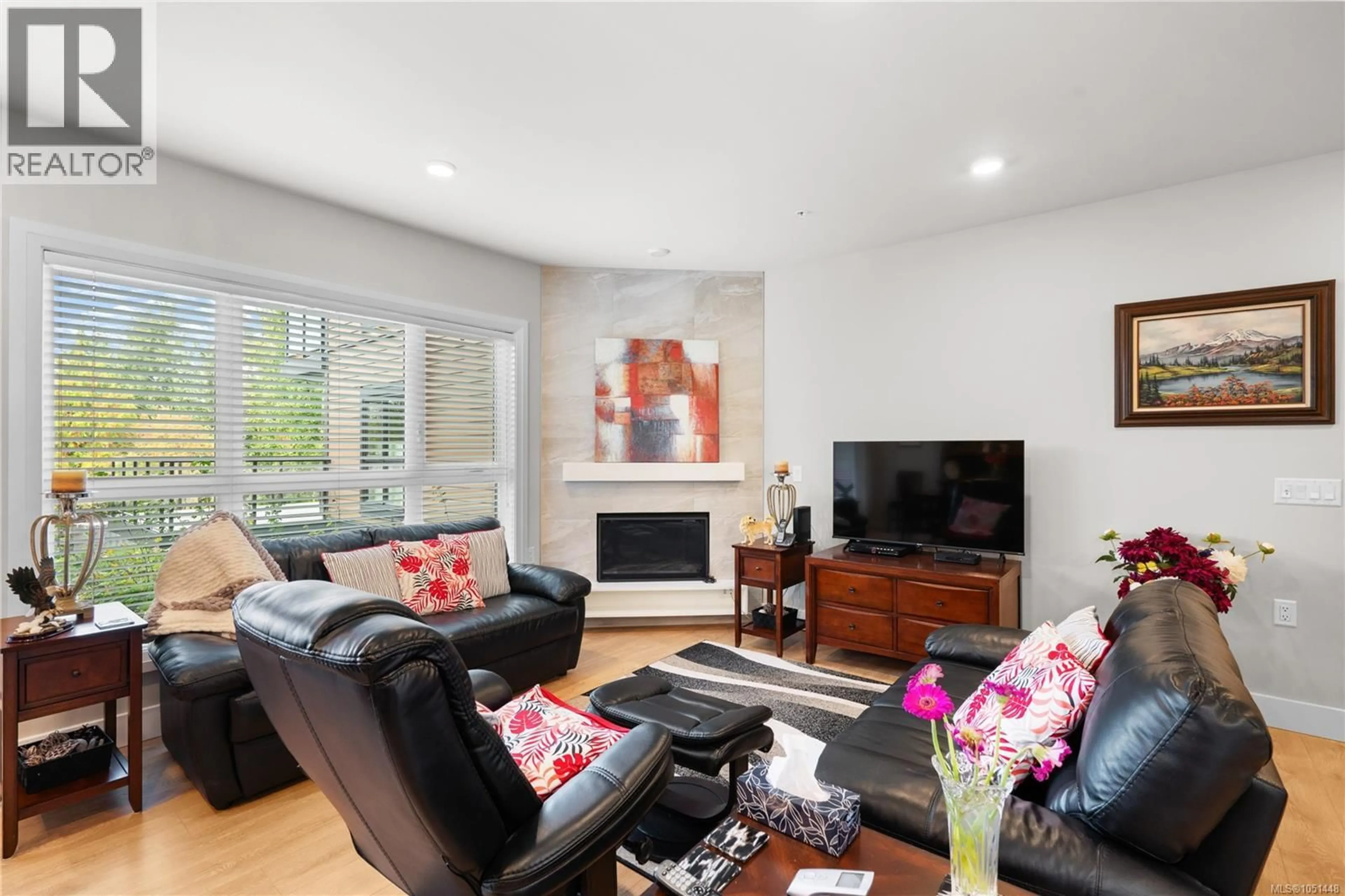 Living room with furniture, wood/laminate floor for 205 - 741 TRAVINO LANE, Saanich British Columbia V8Z0G3