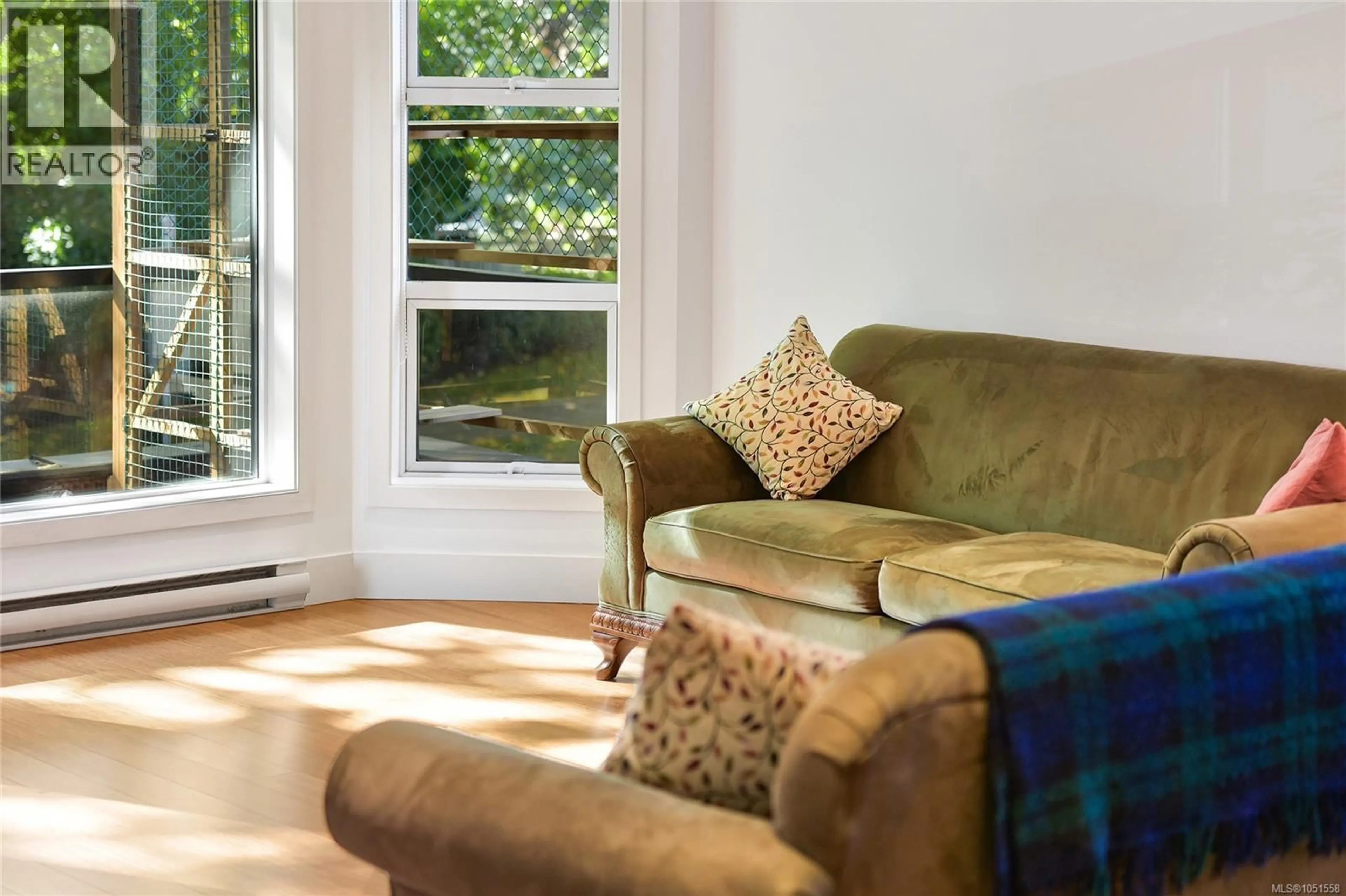 Living room with furniture, wood/laminate floor for 206 - 2589 PENRHYN STREET, Saanich British Columbia V8N1G4