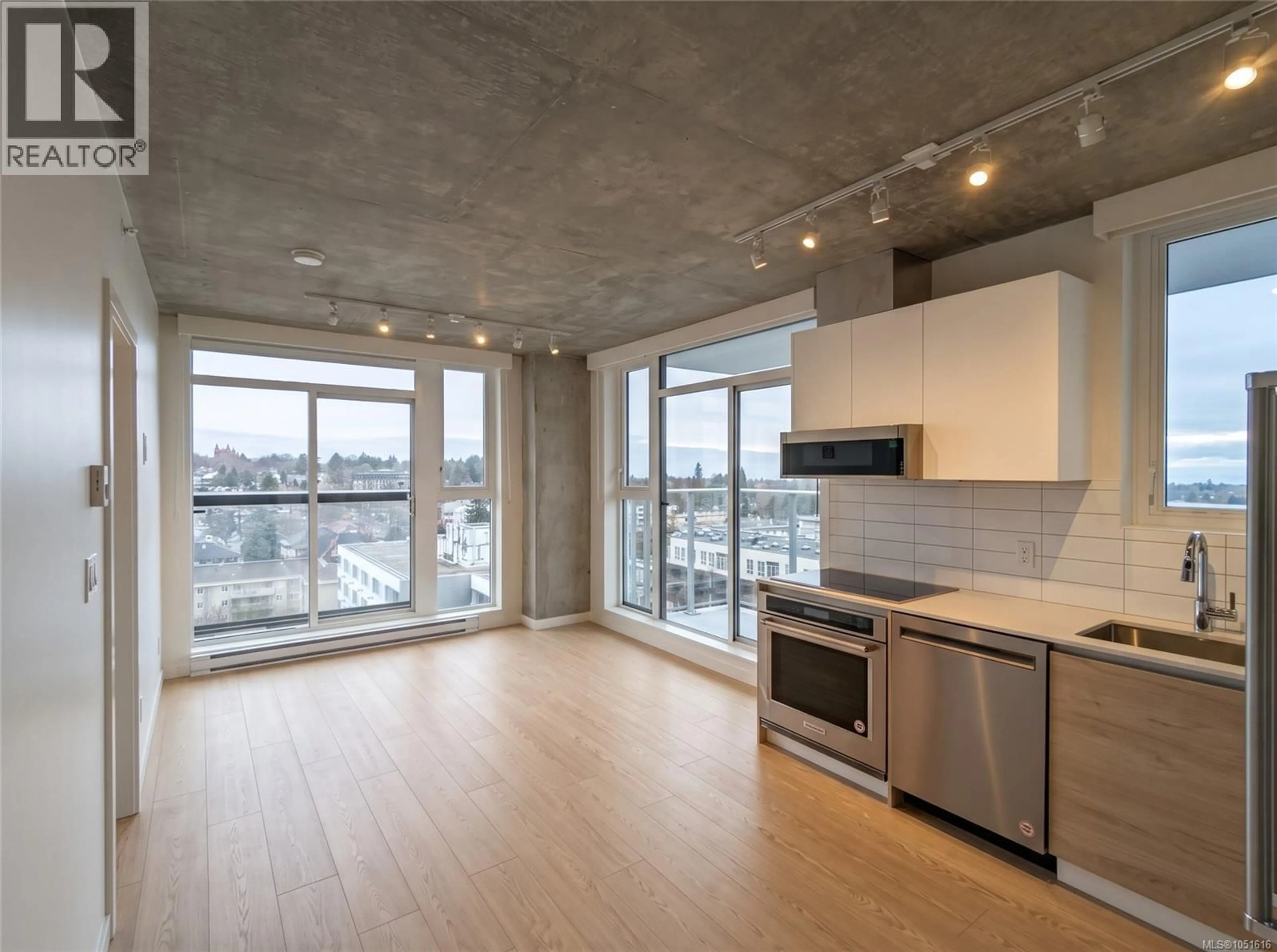 Open concept kitchen, cement floor for 1207 - 1097 VIEW STREET, Victoria British Columbia V8V0G9