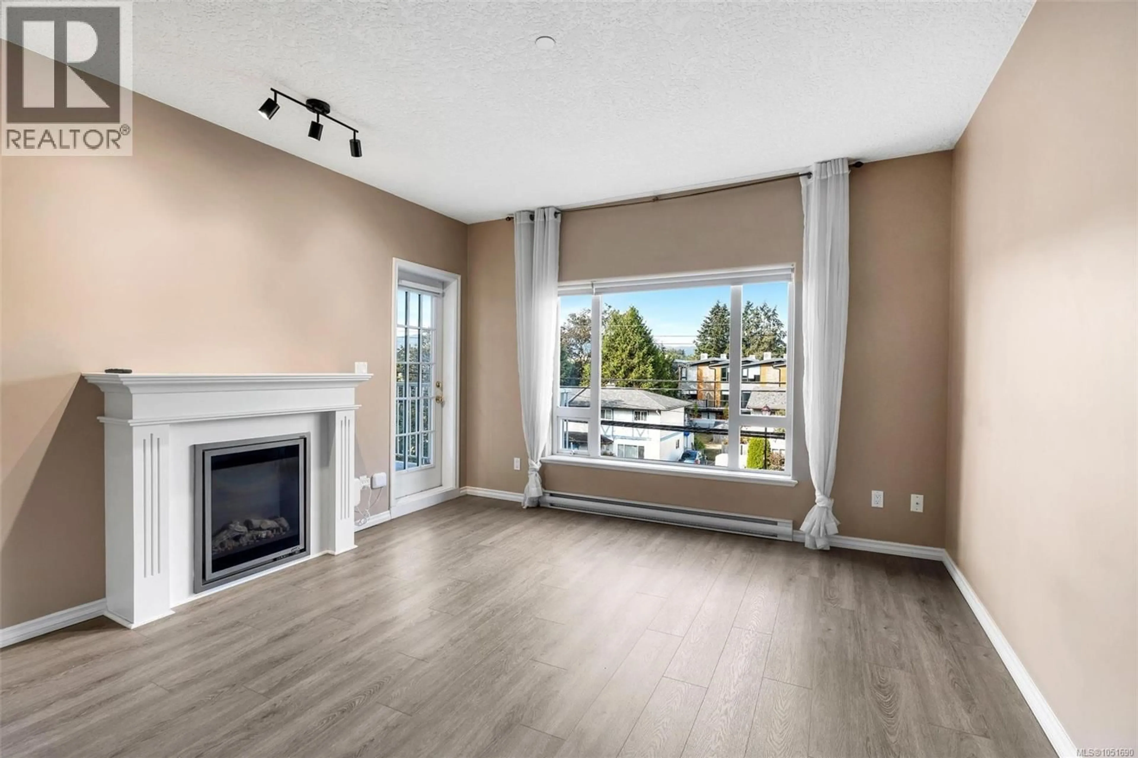 Living room with furniture, wood/laminate floor for 307 - 2823 JACKLIN ROAD, Langford British Columbia V9B3Y1