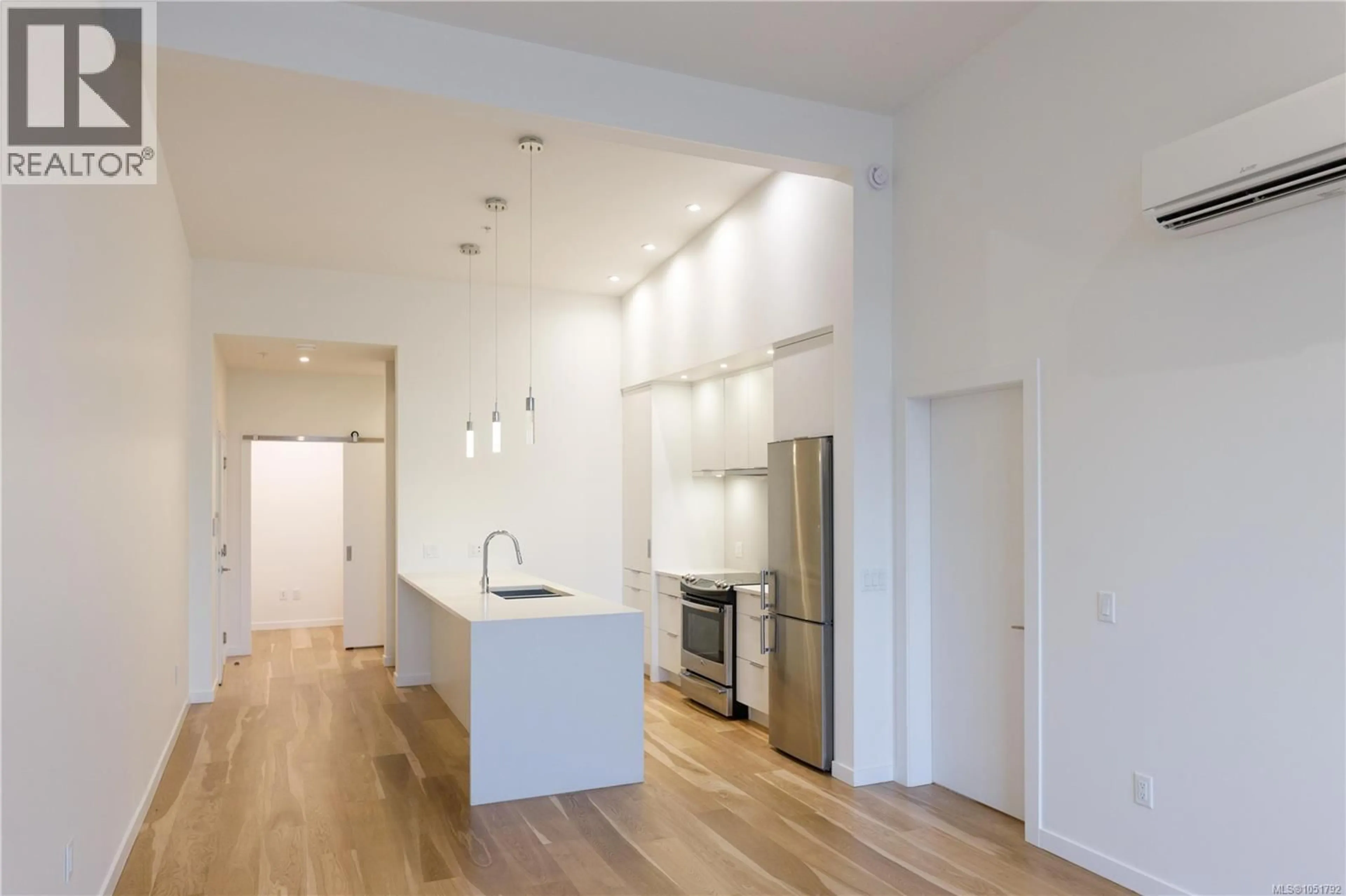 Open concept kitchen, wood/laminate floor for 201 - 139 CORFIELD STREET SOUTH, Parksville British Columbia V9P1A1