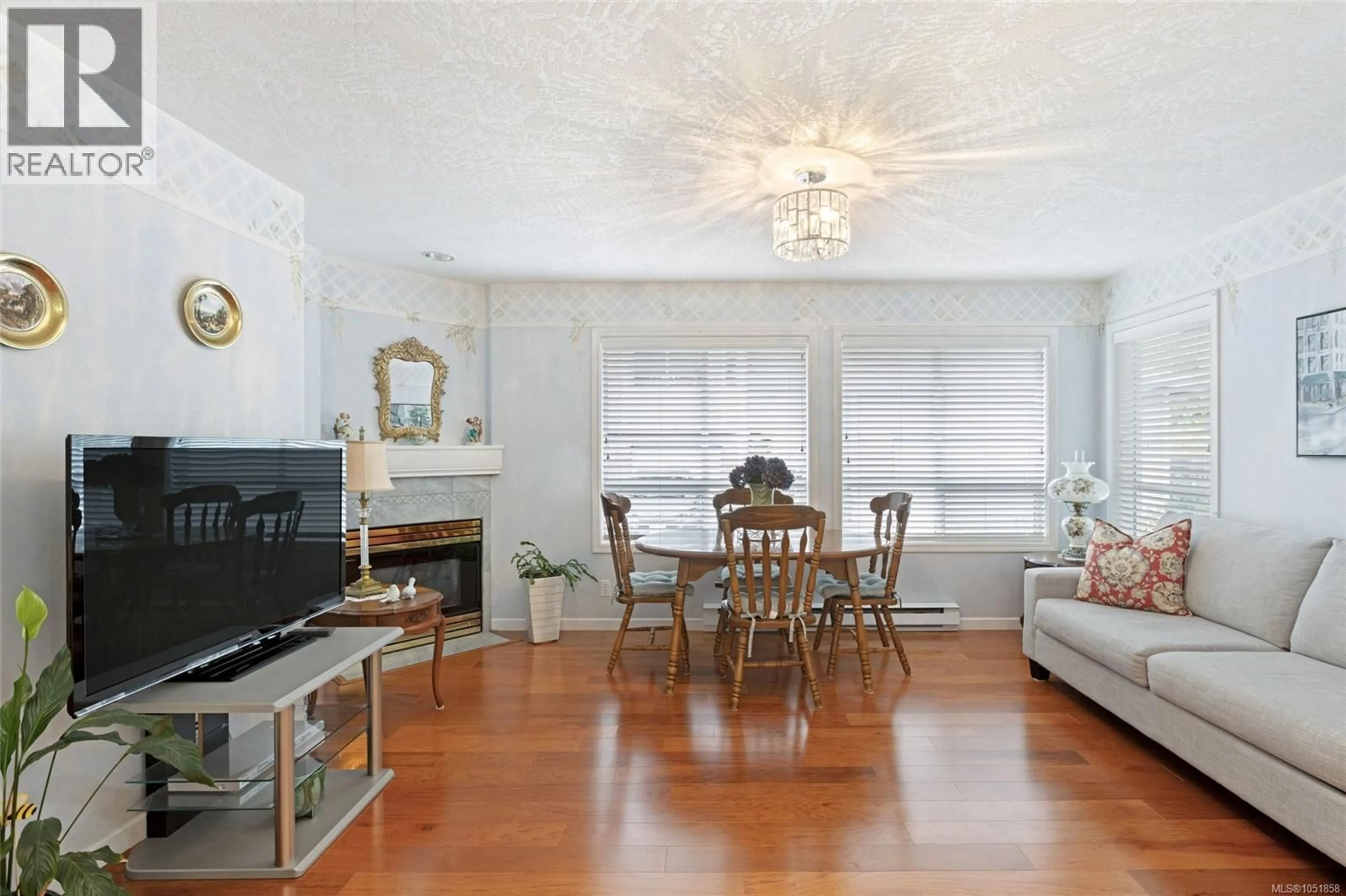 Living room with furniture, wood/laminate floor for 13 - 4619 ELK LAKE DRIVE, Saanich British Columbia V8Z5M2